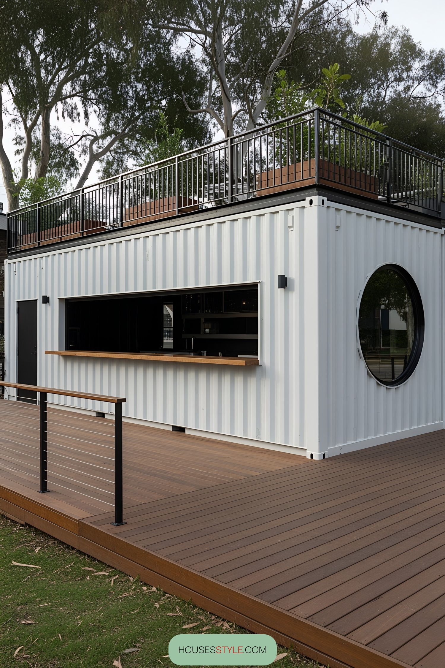 Modern container bar with circular window and wooden deck