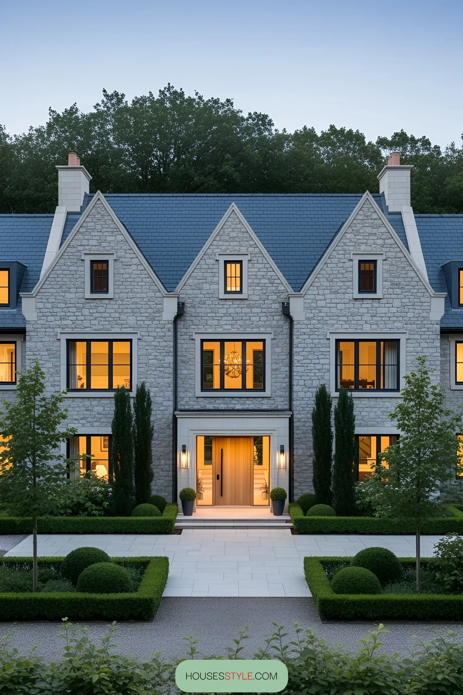 Contemporary country manor house with a stone façade and landscaped garden