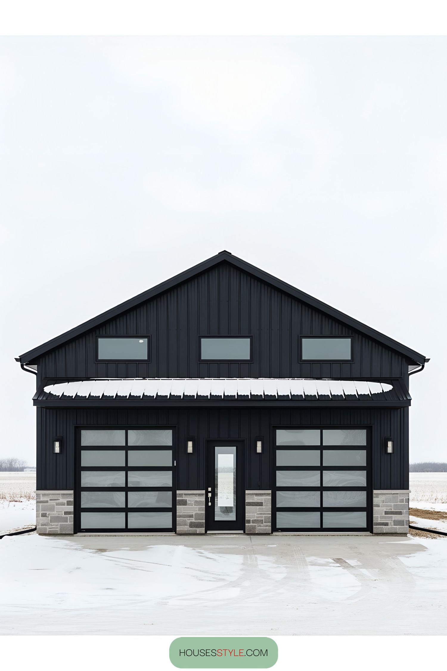 Sleek black barn house with glass doors and stone accents