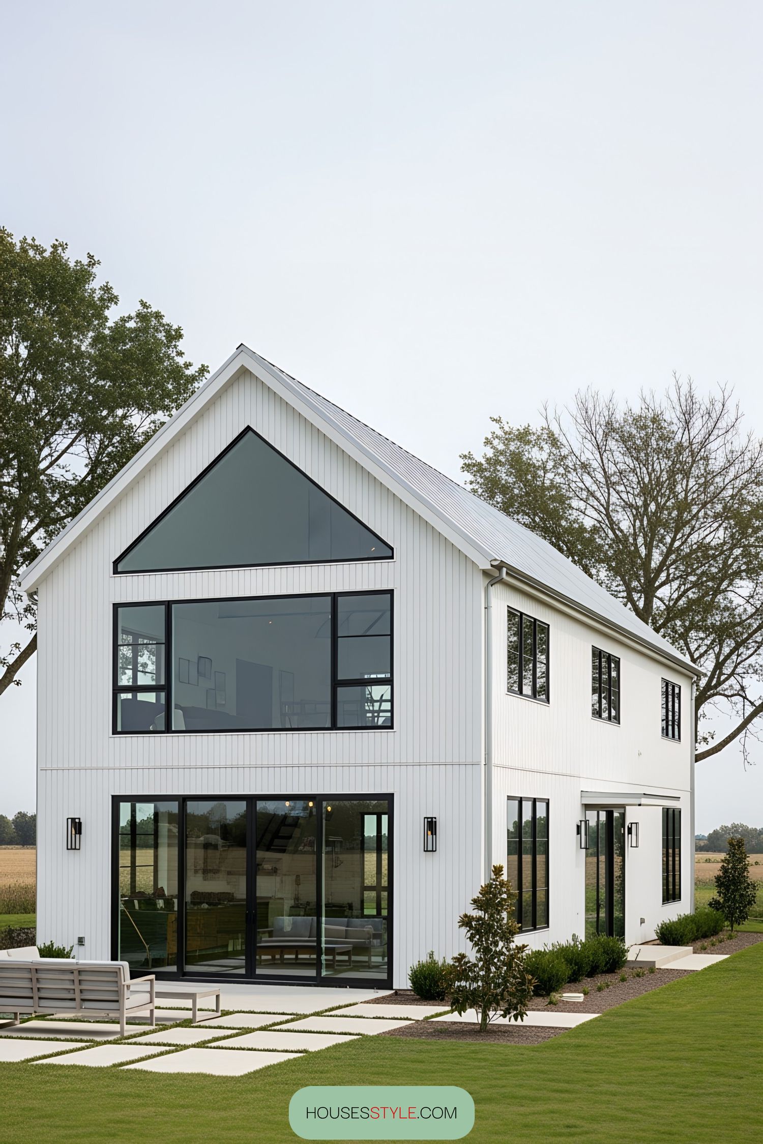 Modern white barn house with large windows and sleek design