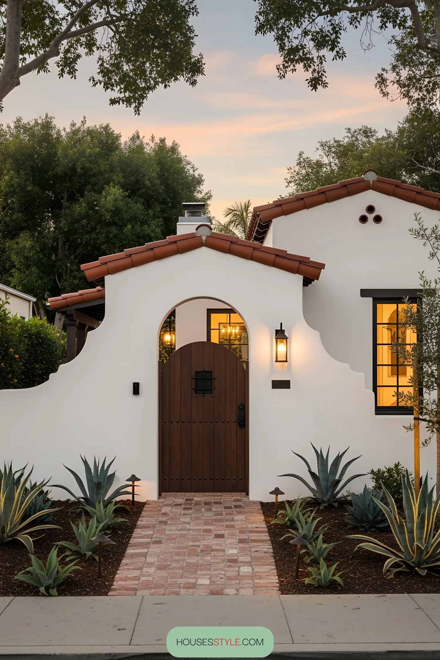 Spanish coastal house exterior with arch and plants