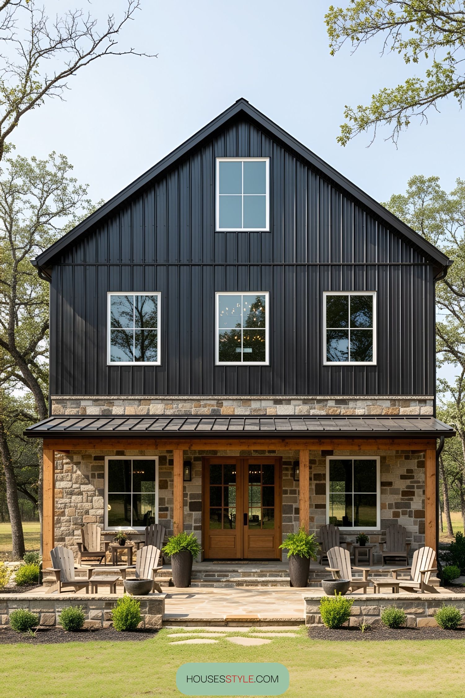 Cozy black pole barn house with rustic charm