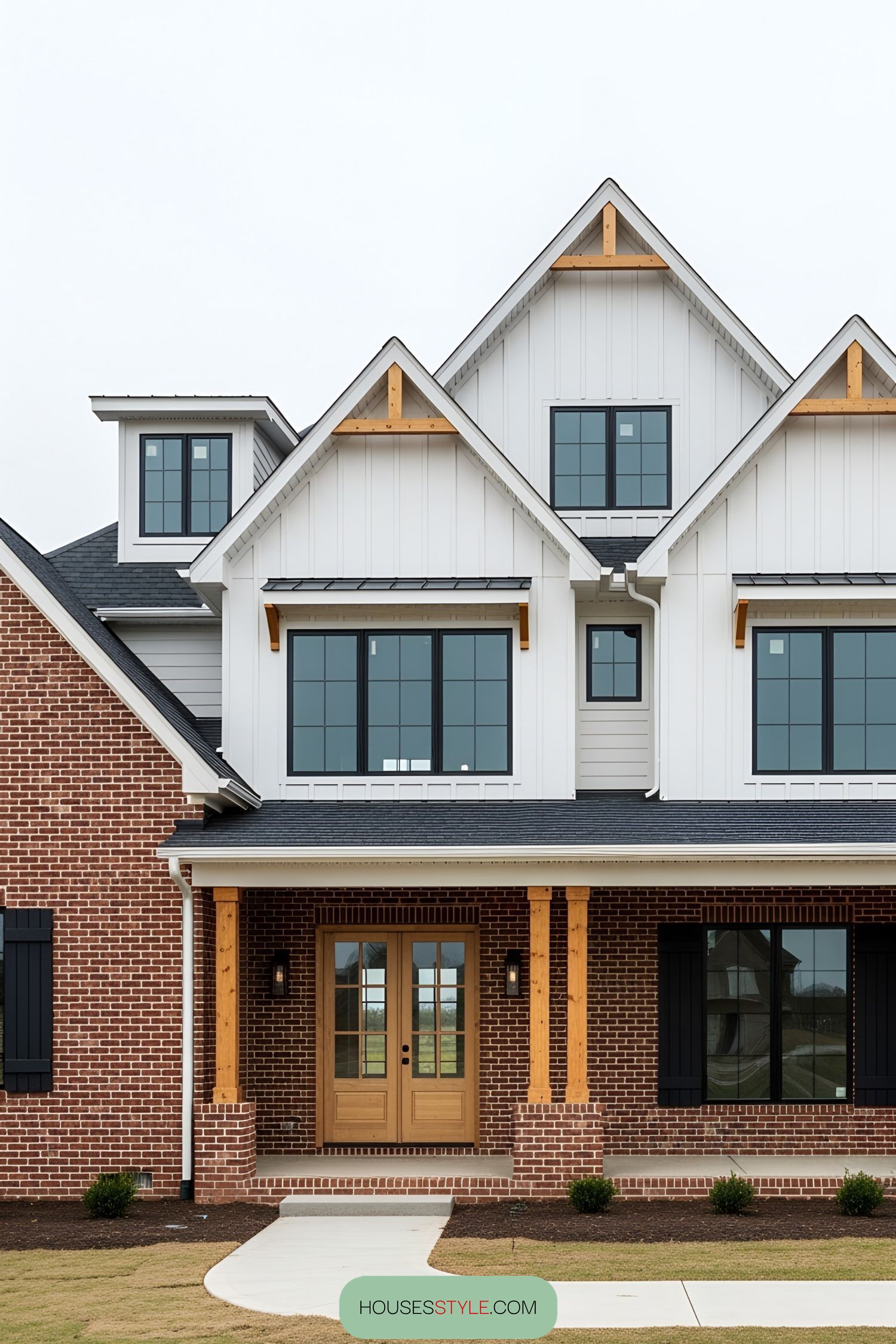 Two-story brick house with white gables and large windows
