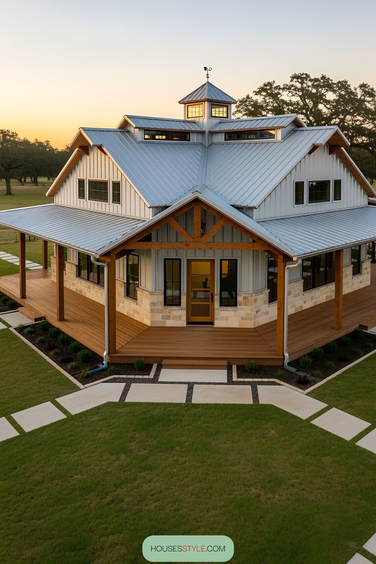Barndominium with a blue metal roof and expansive deck