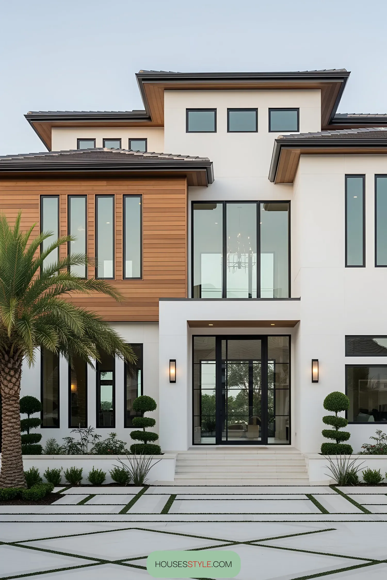 Modern coastal house exterior with palm tree and geometric landscaping