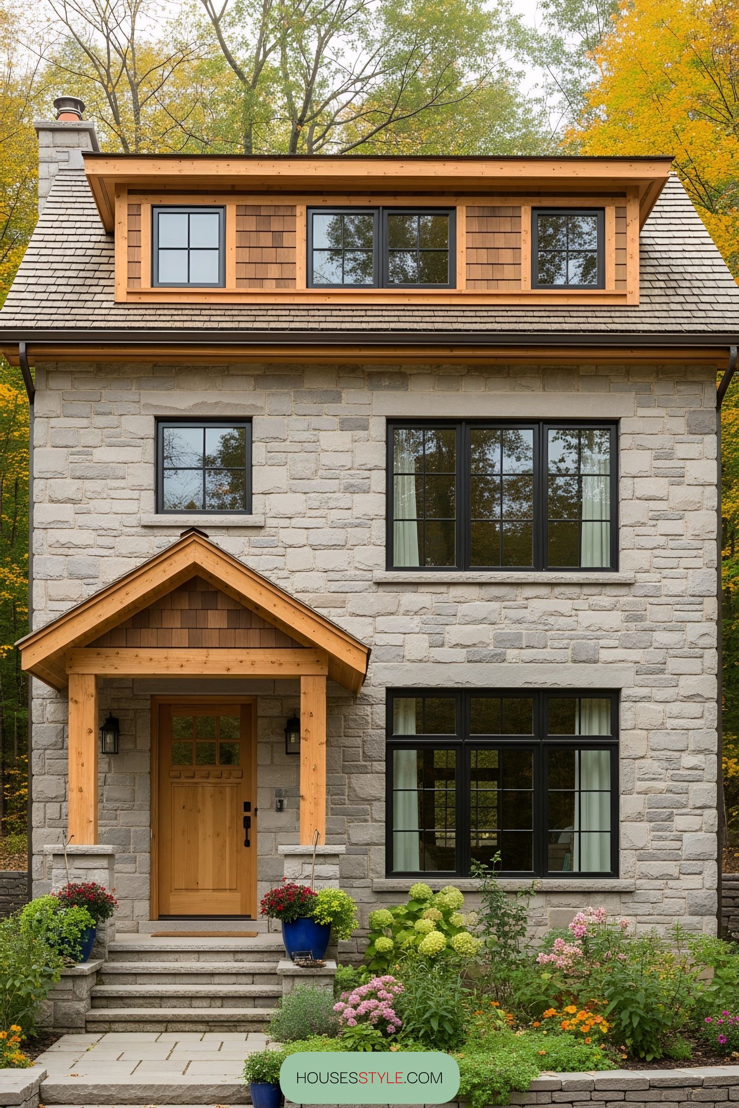 Small stone house with wooden accents surrounded by a lush garden