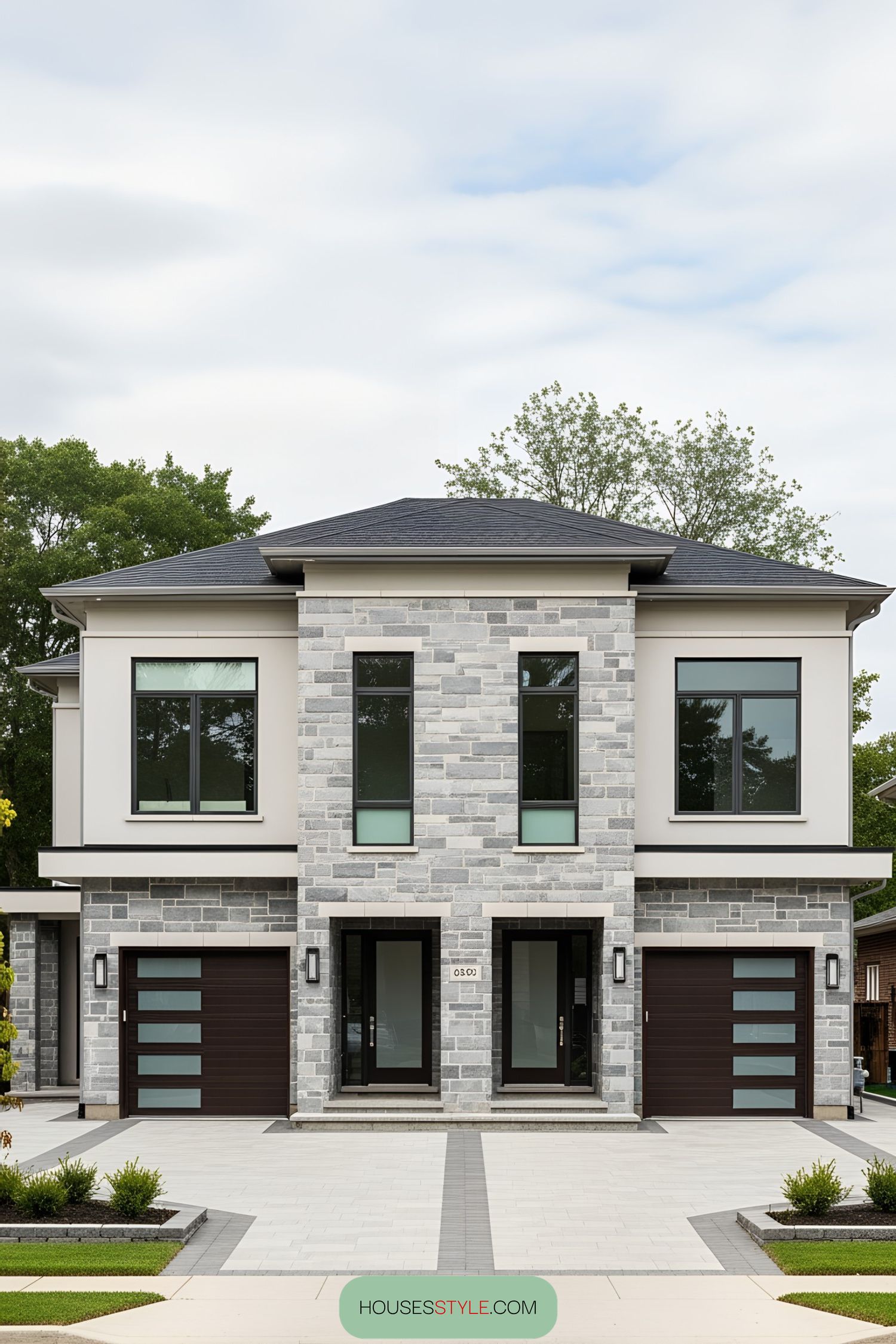 Front view of a stylish modern duplex with stone facade