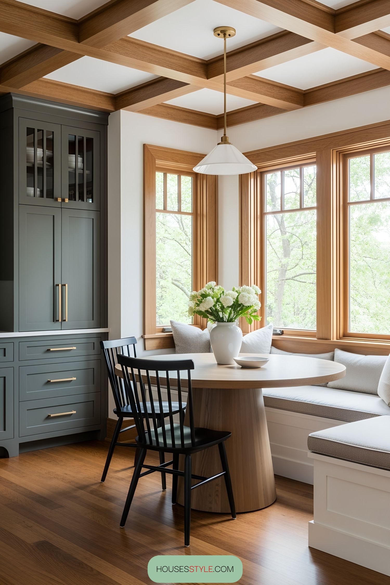 A cozy breakfast nook with wooden accents and a vase of flowers