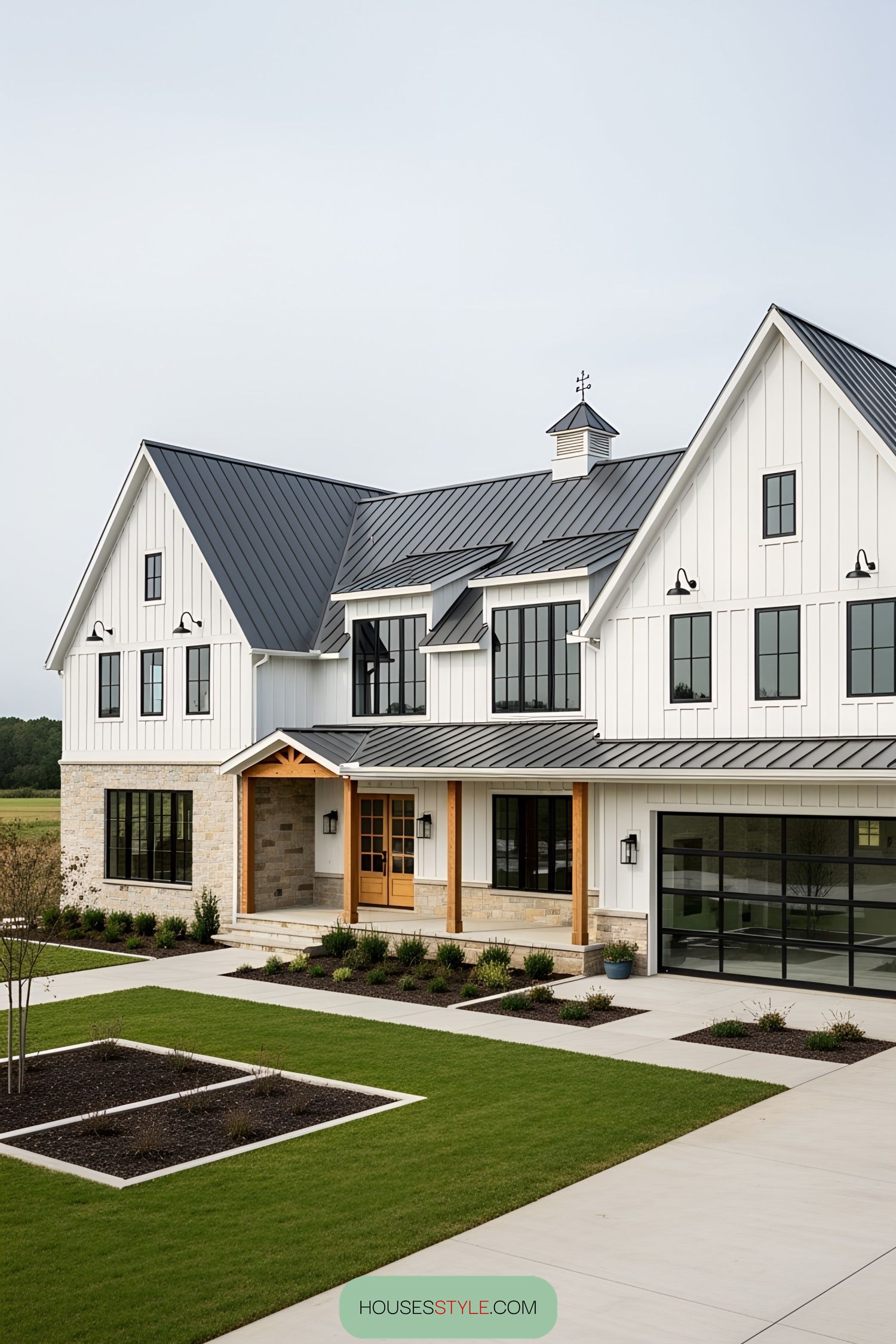 Sleek modern white barn house with manicured lawn