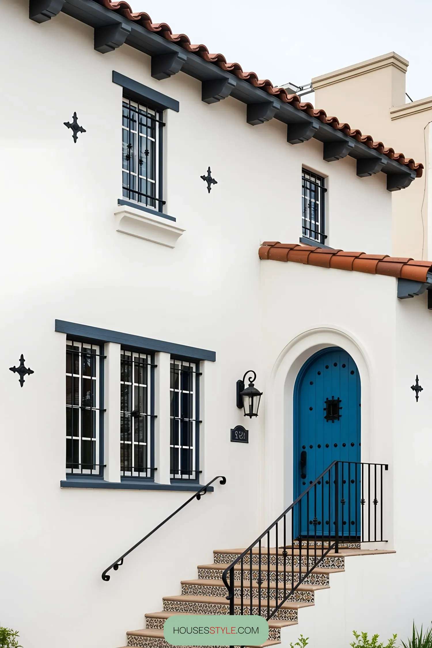 White house facade with a vibrant blue door