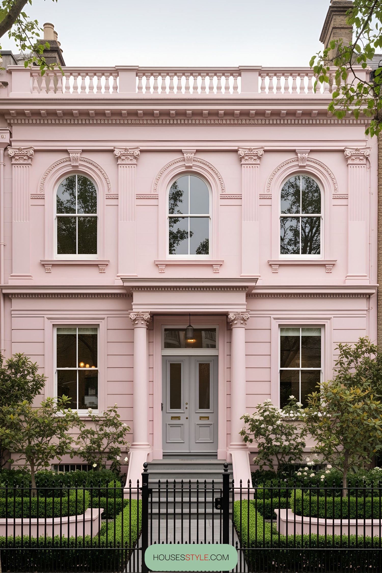 Elegant pink Victorian house with symmetrical design