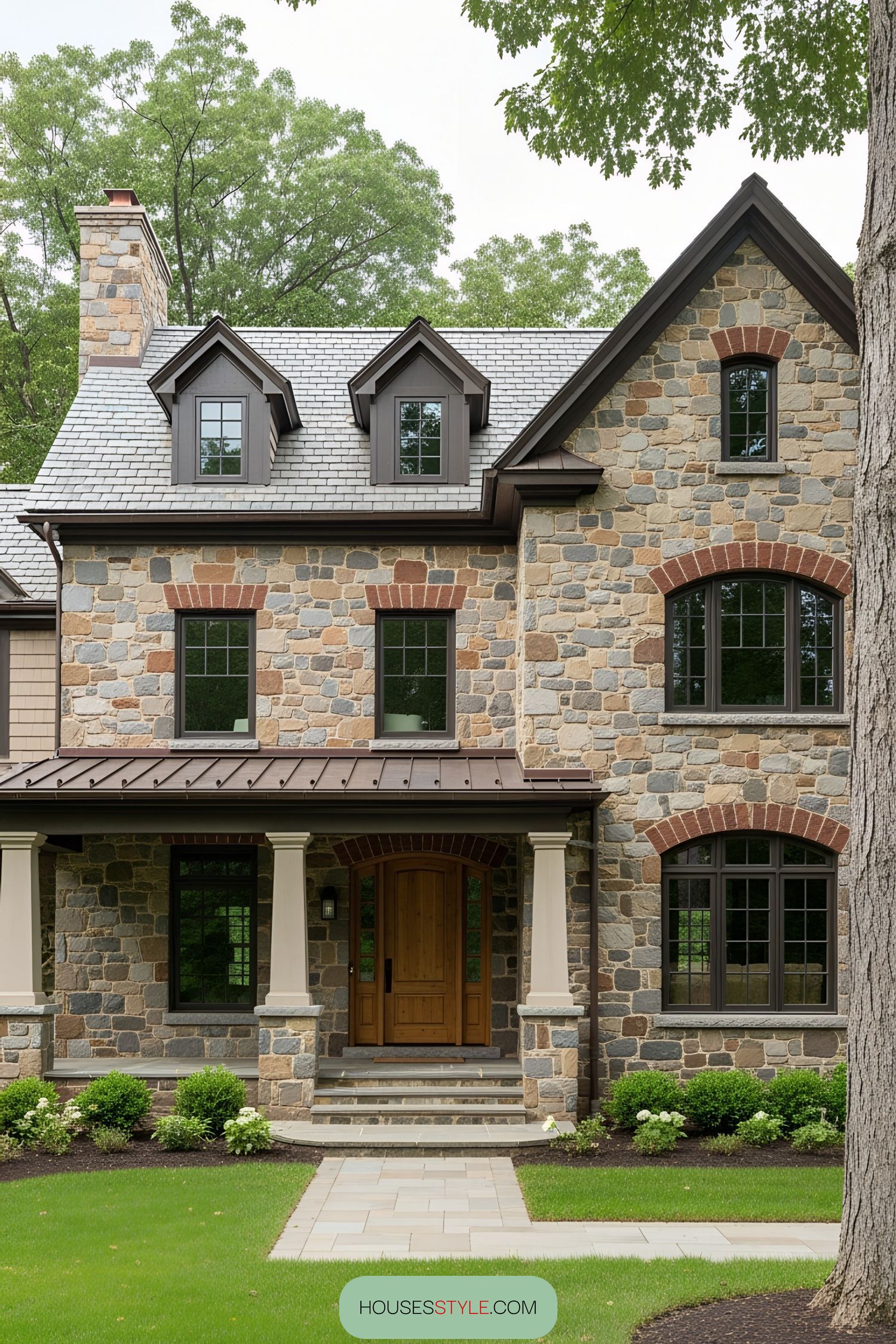 Inviting stone farmhouse with arched windows and trees