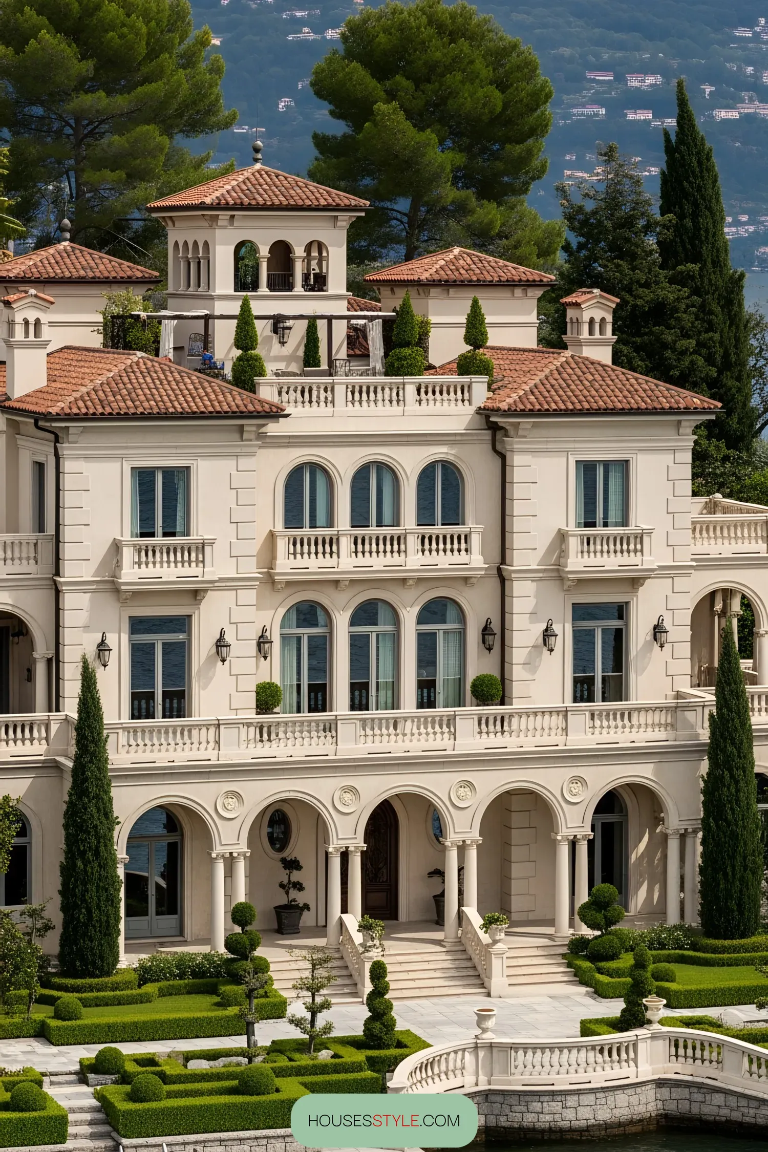 Elegant lakefront mansion with grand arches and lush gardens