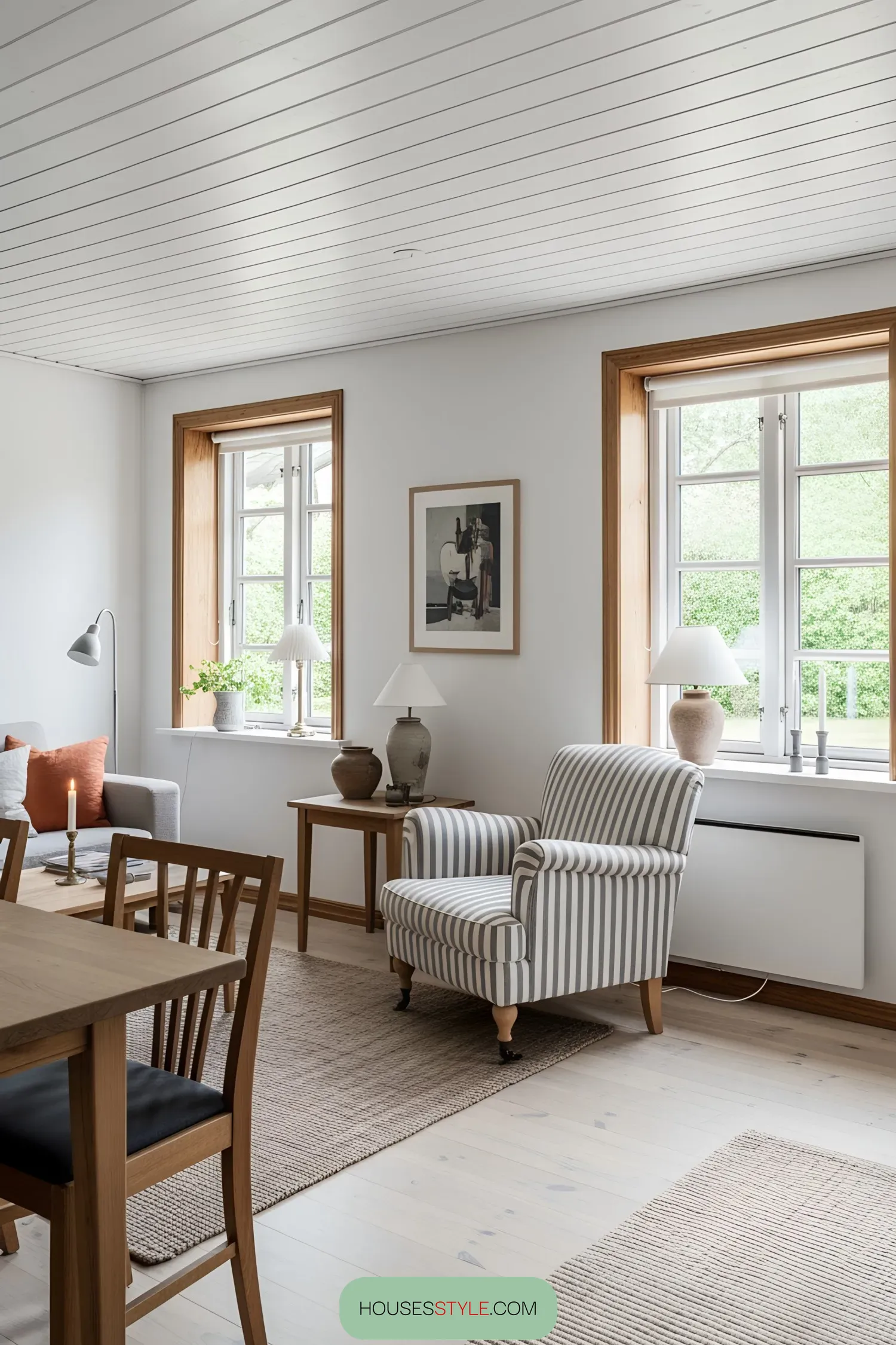 Cozy chair next to wooden windows in a Swedish cottage