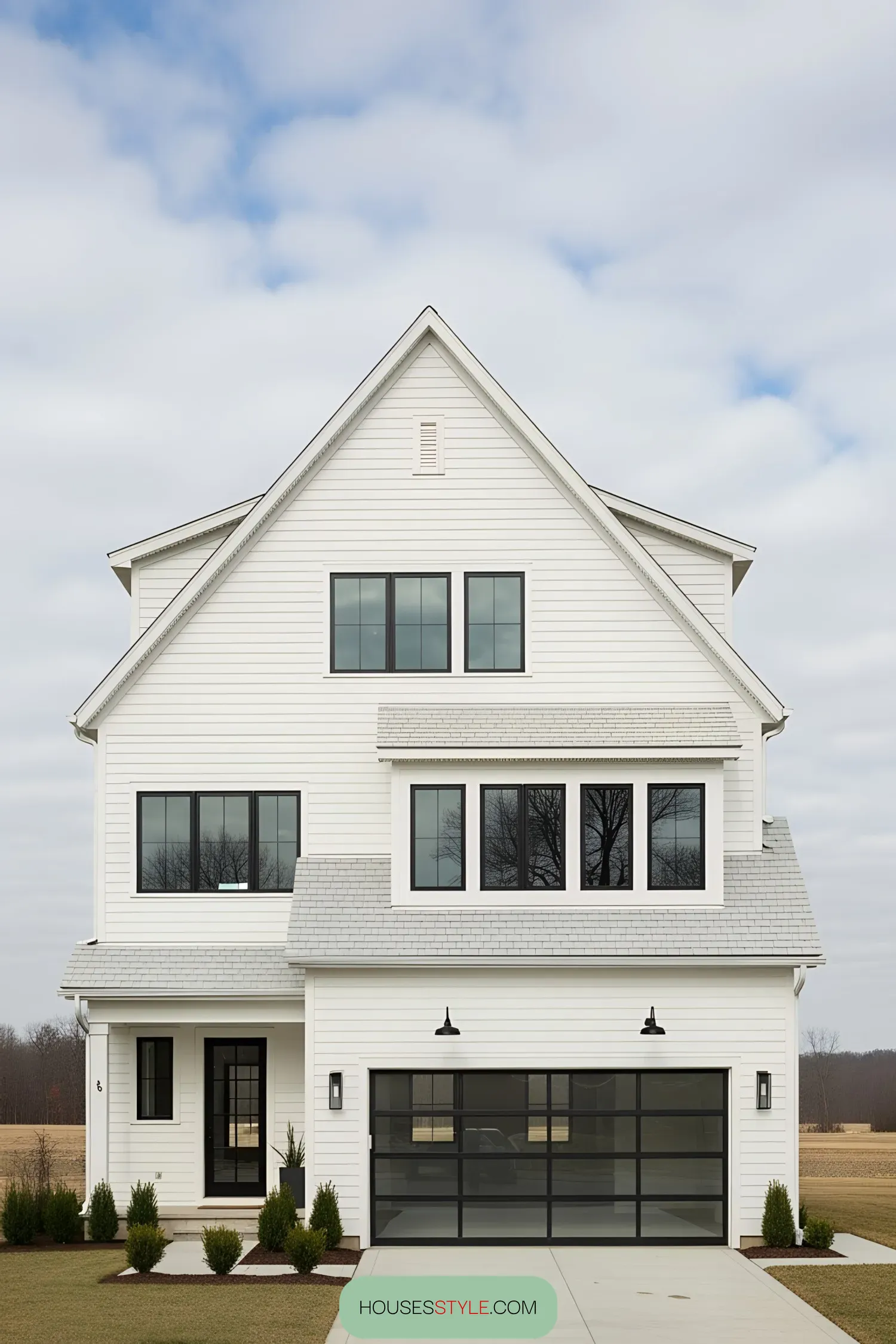 Farmhouse with large windows and glass garage door