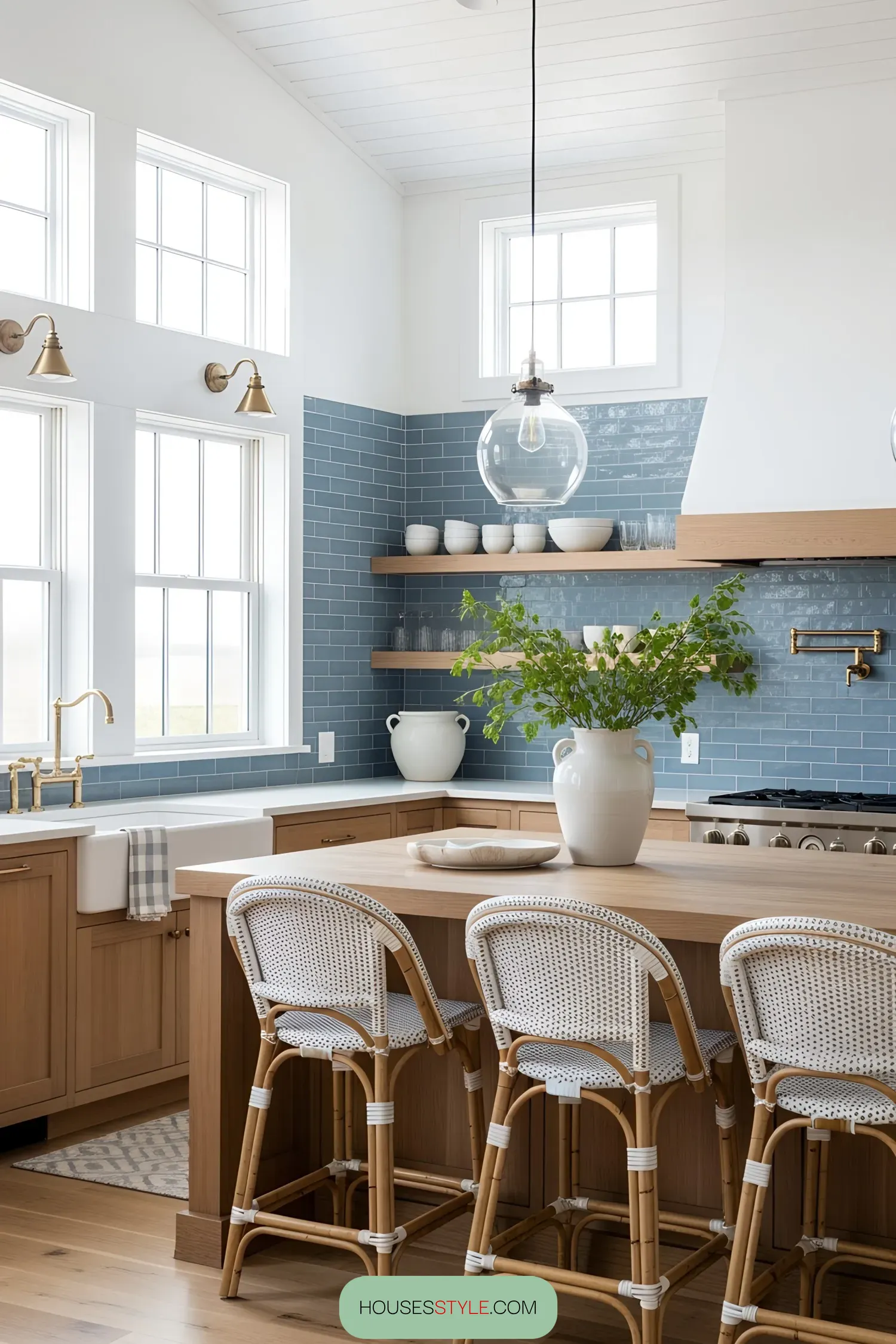 Bright and airy coastal kitchen with blue tiles and wicker stools