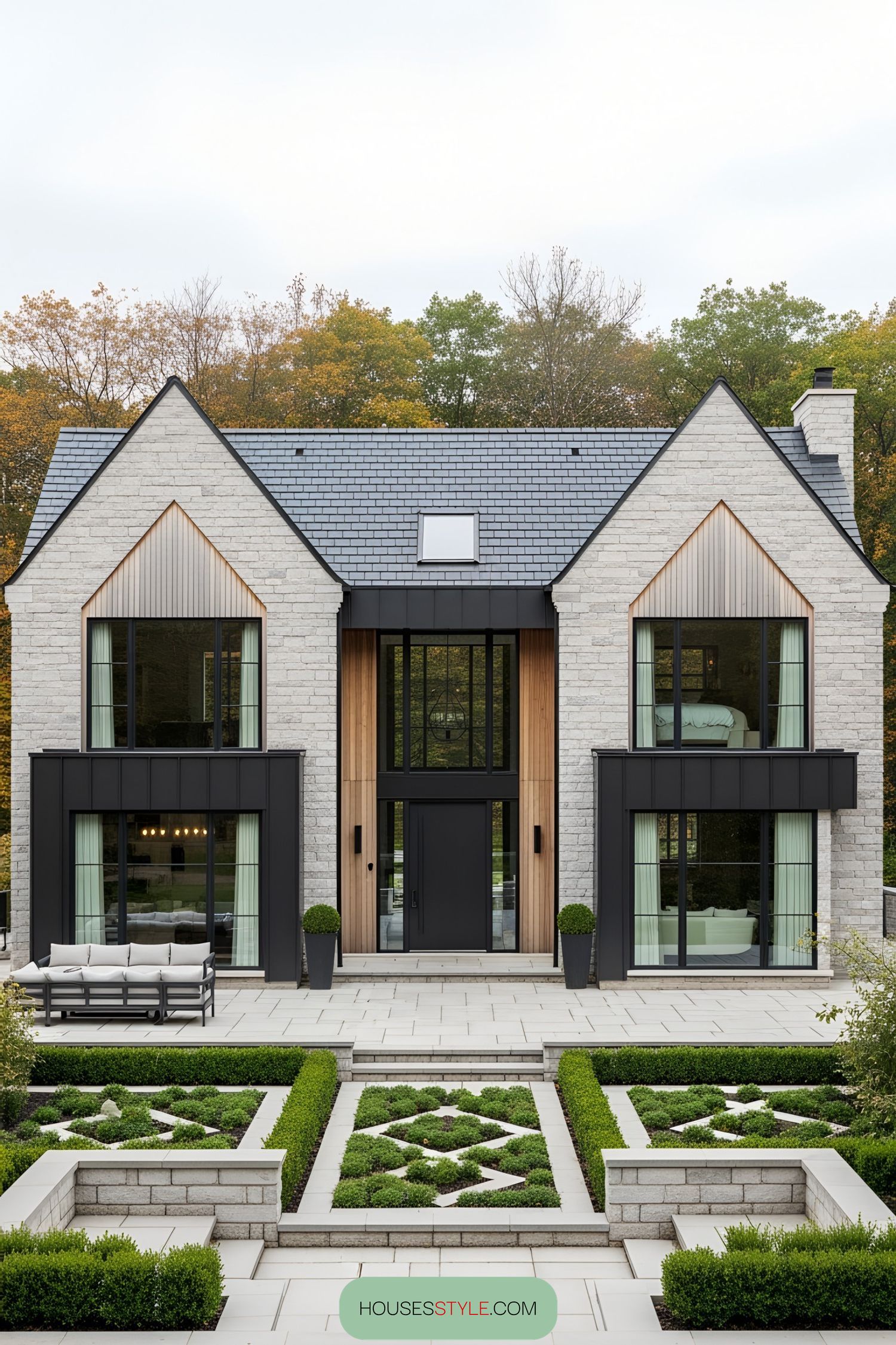 Elegant brick farmhouse with large windows and manicured garden