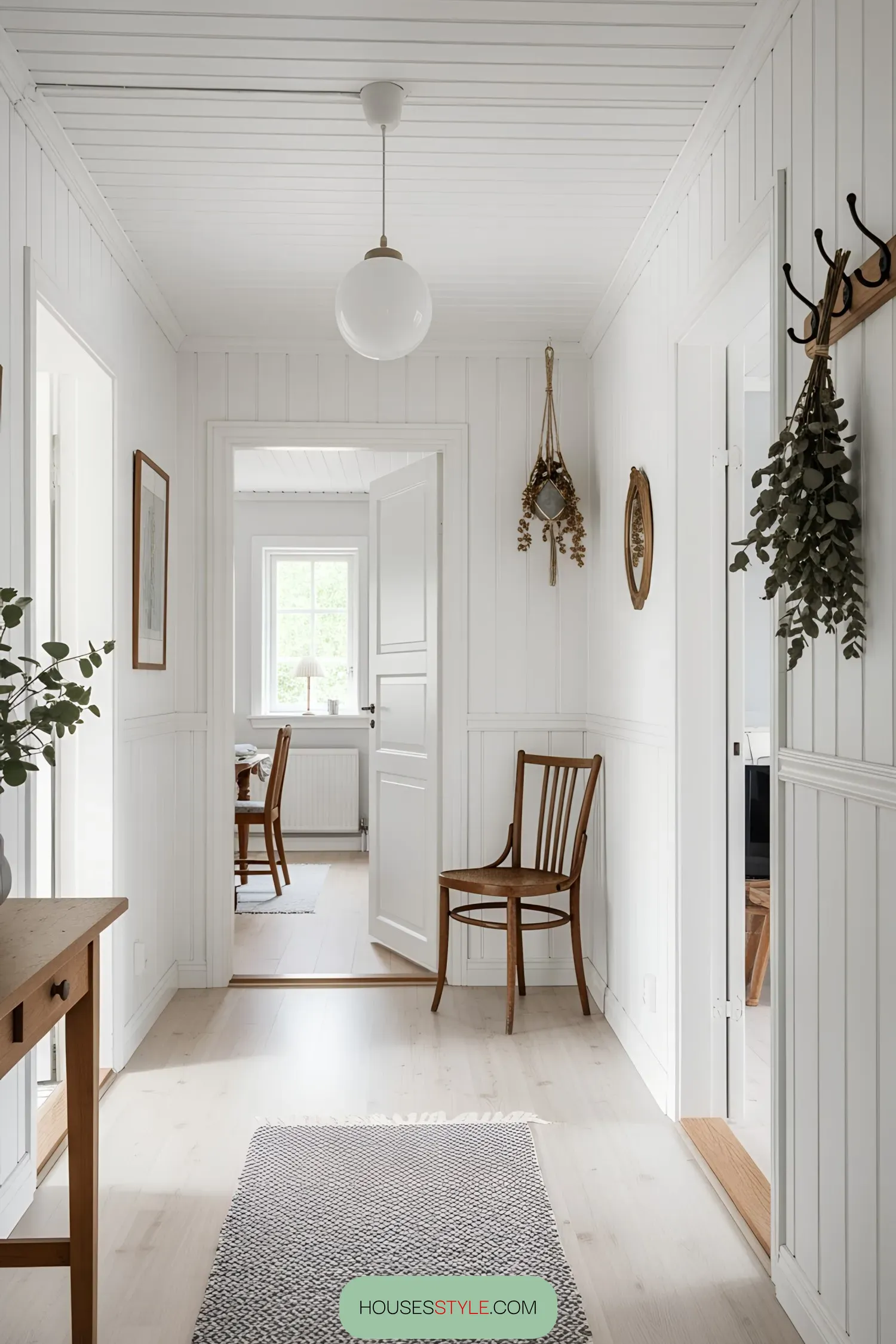 Bright Swedish hallway with wooden chair and greenery