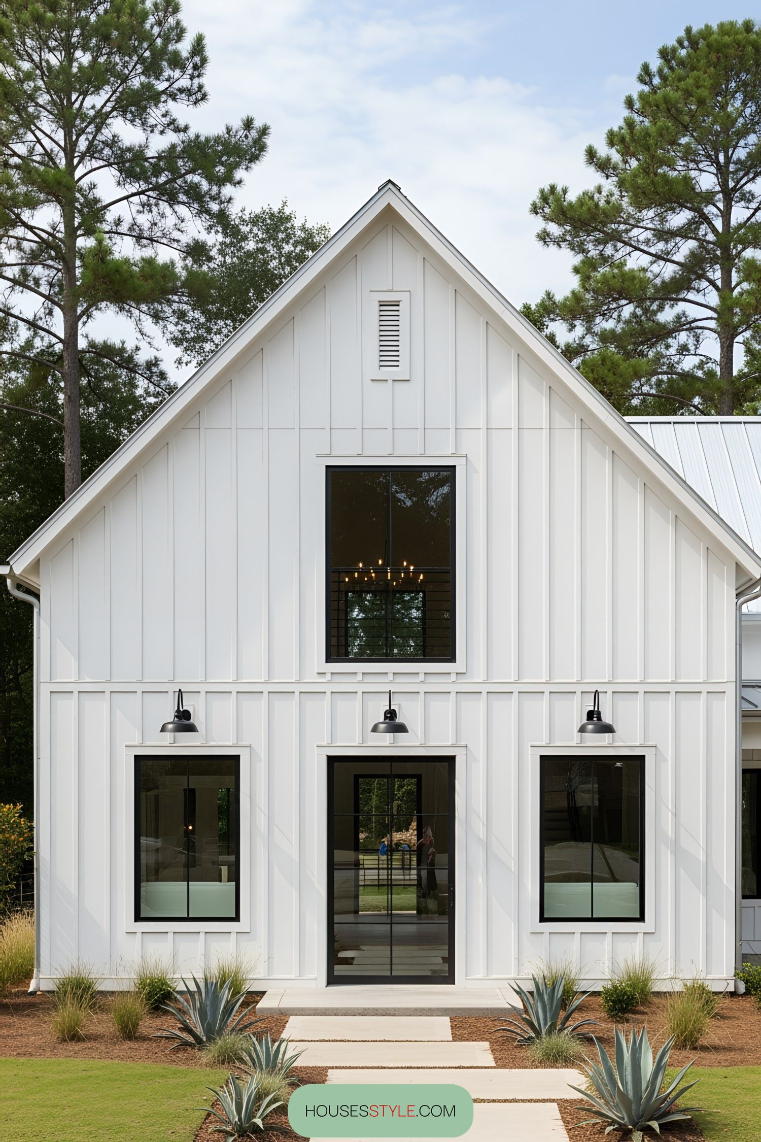 White barn style house with tall, narrow windows