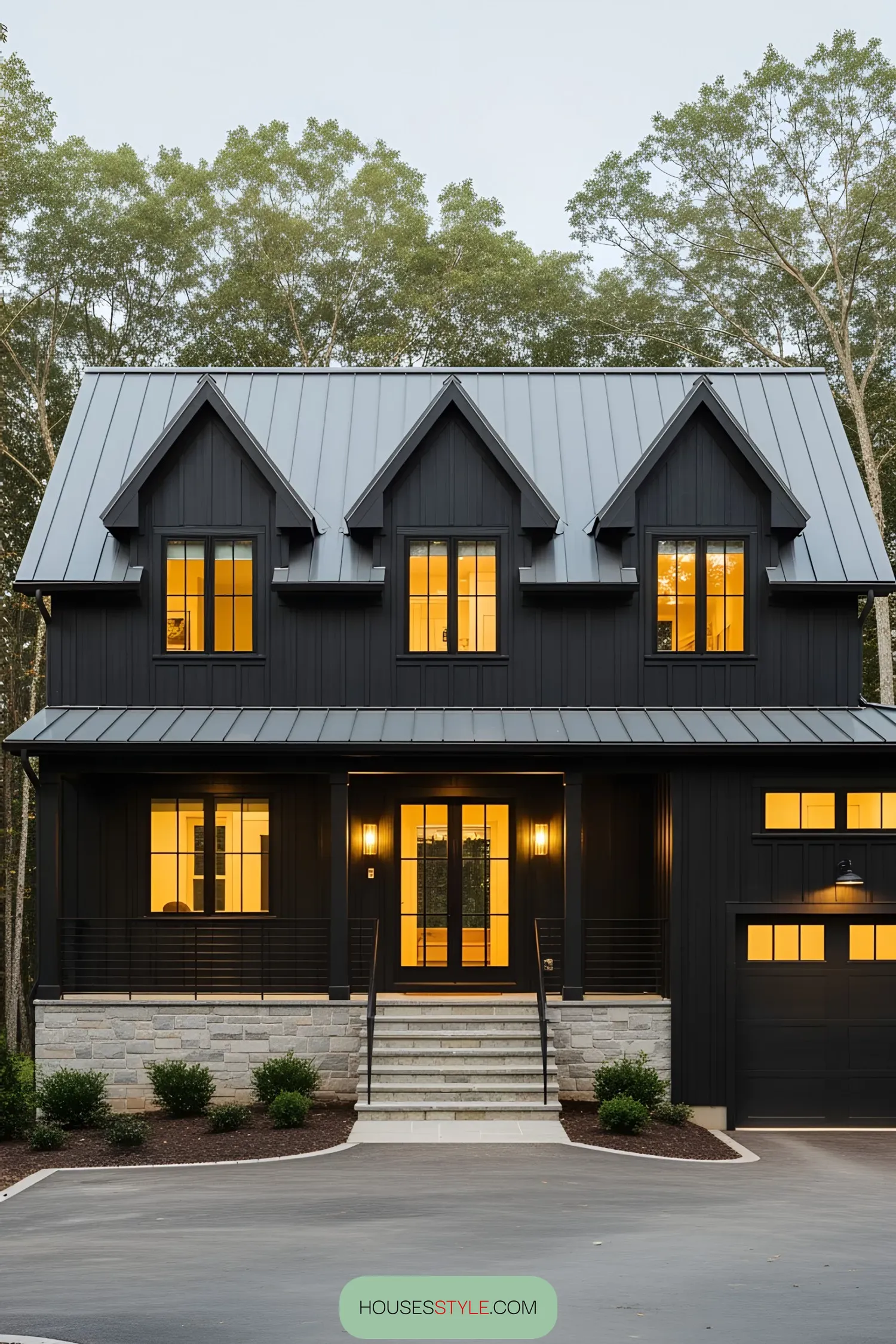 Charming black farmhouse with warm yellow-lit windows