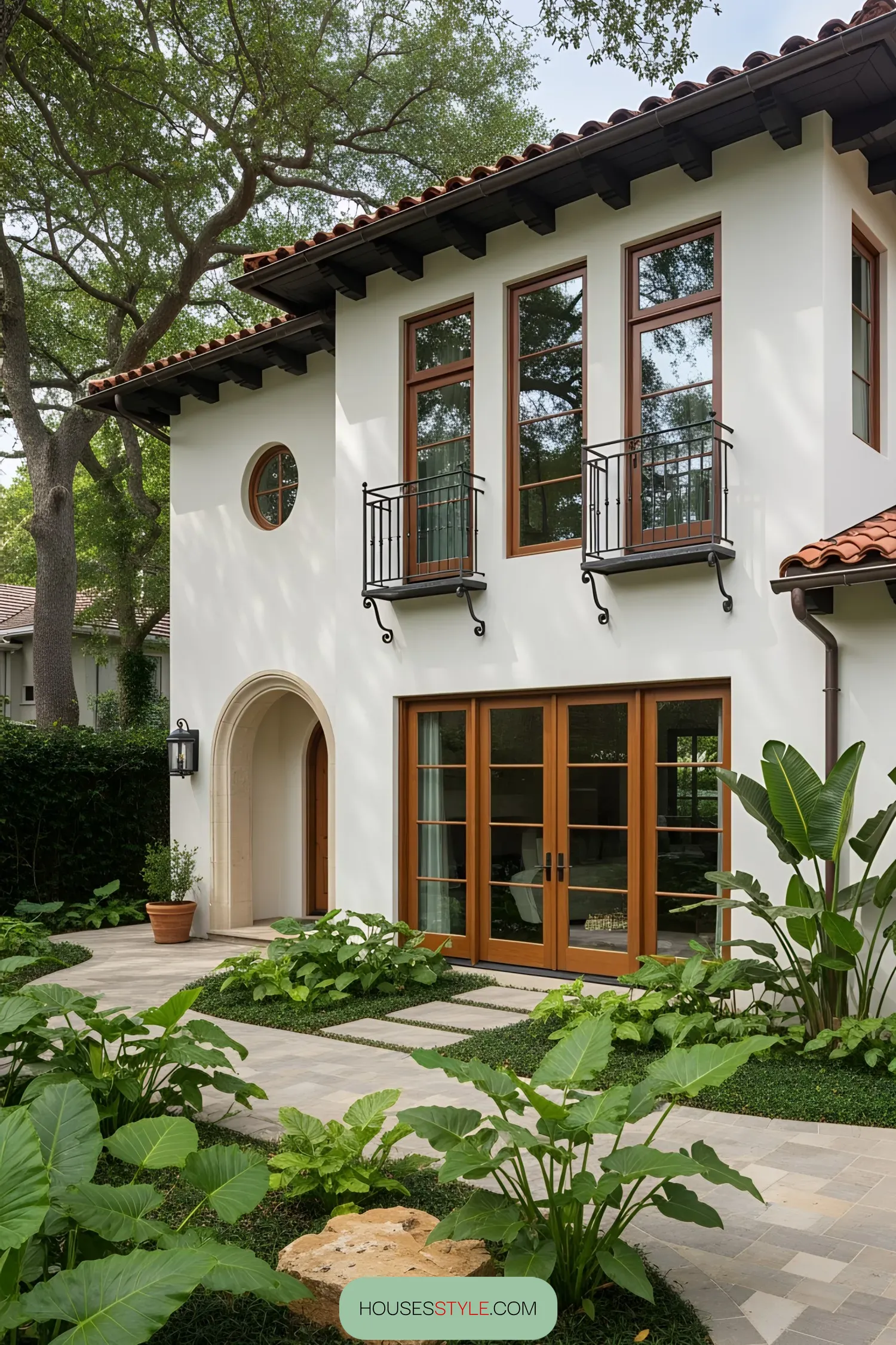 Mediterranean house with lush garden and arched entrance
