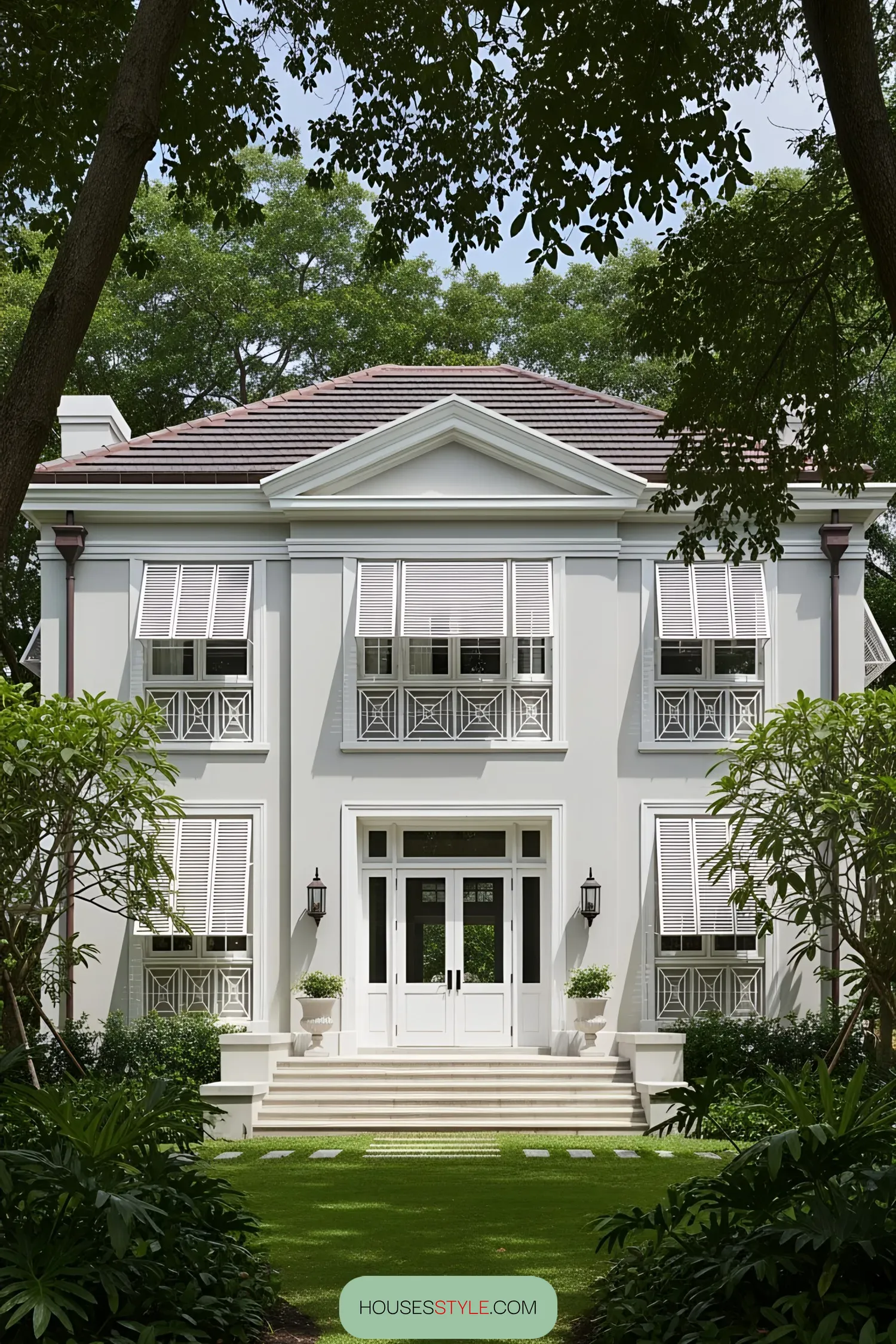 White colonial house with lush greenery