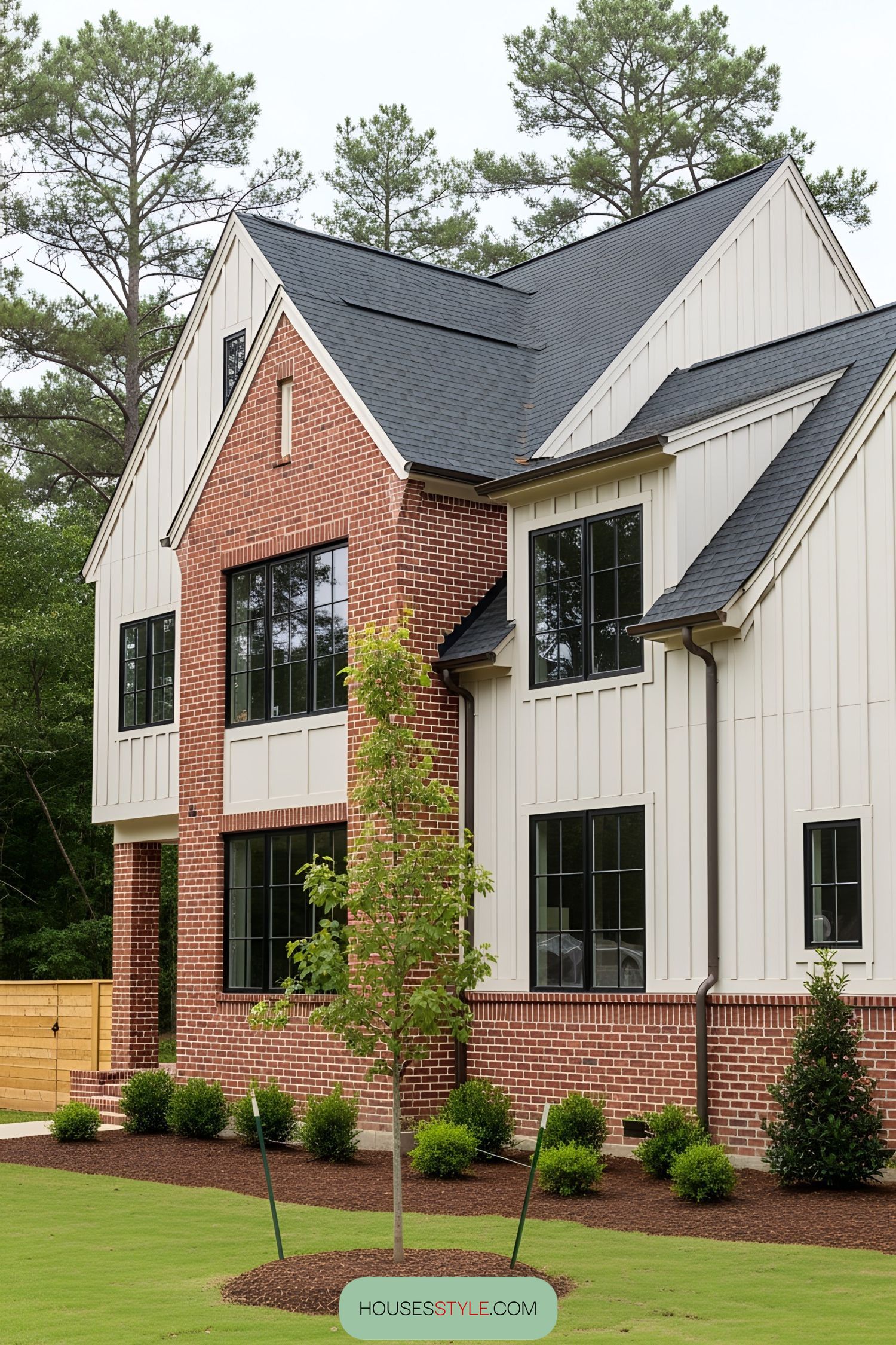 Modern brick farmhouse with black-framed windows