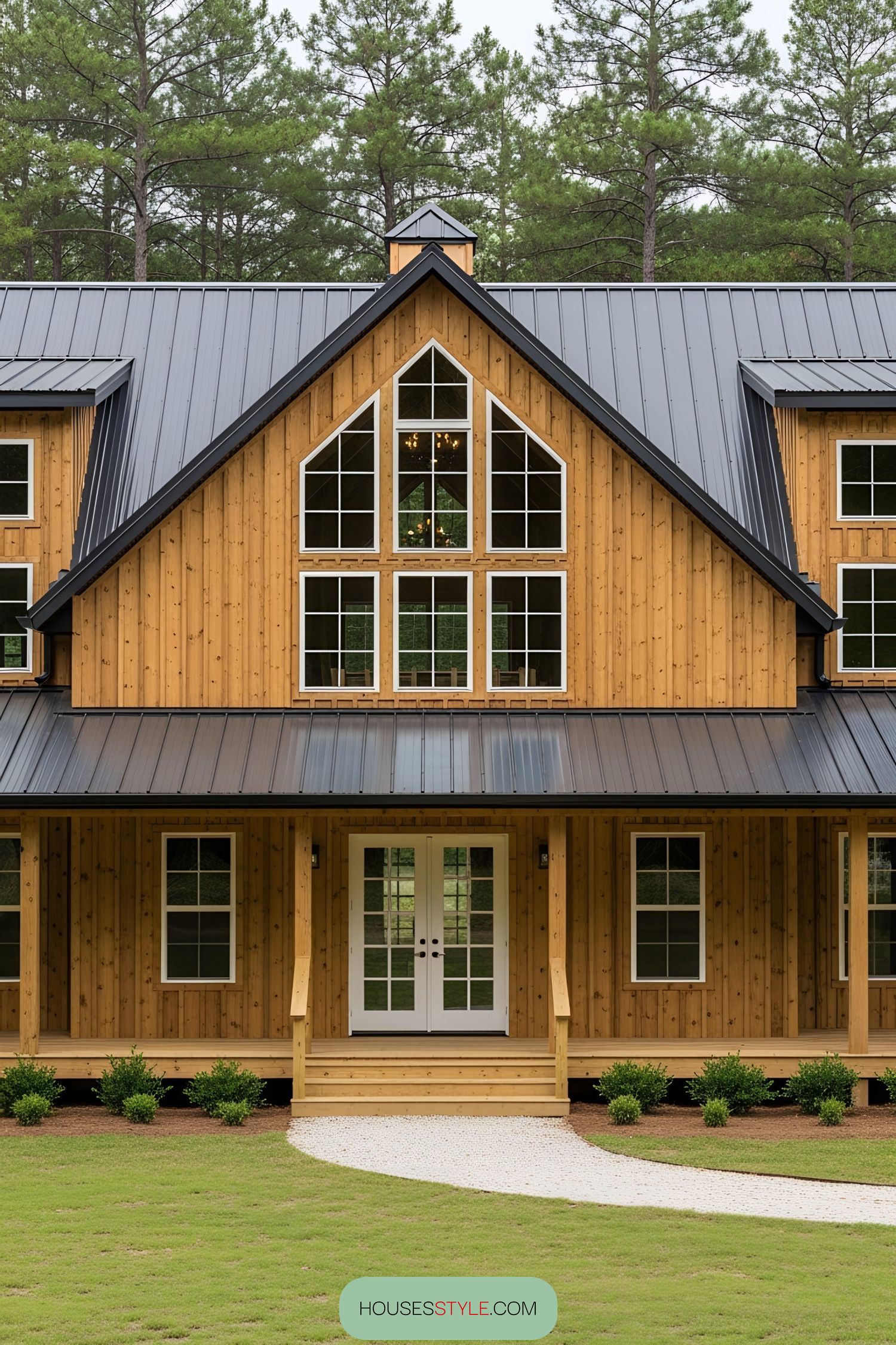 Wooden barnhouse with wraparound porch and metal roof