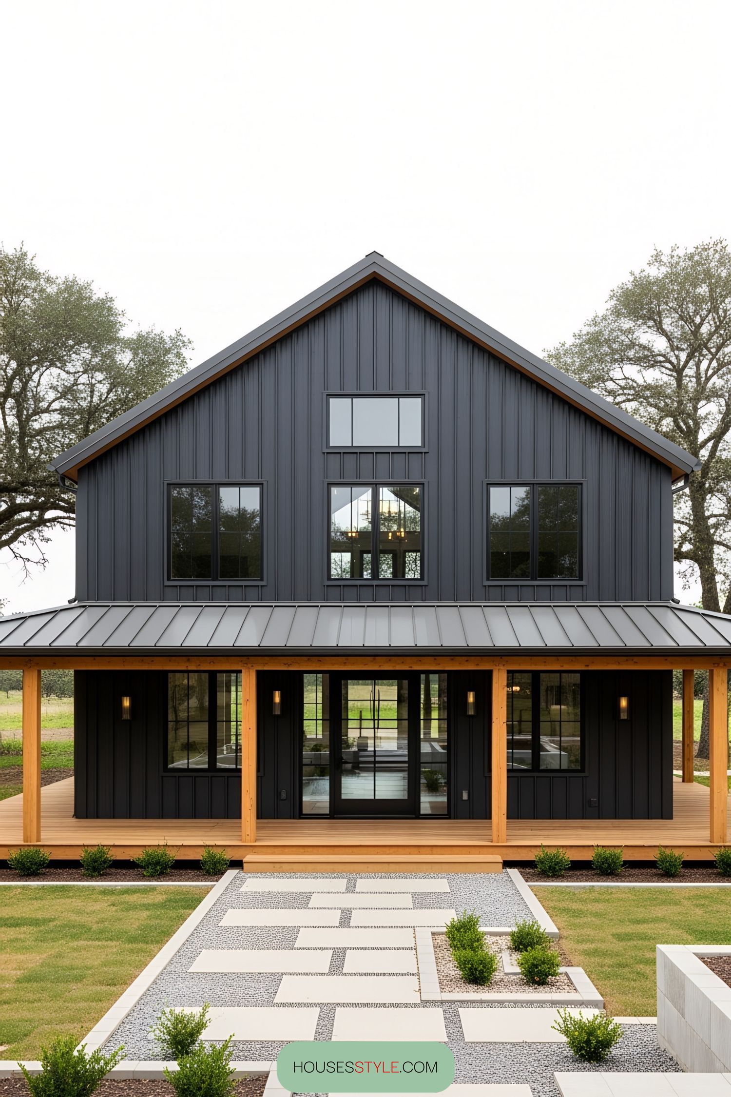 Black barn house with wood accents and modern landscaping