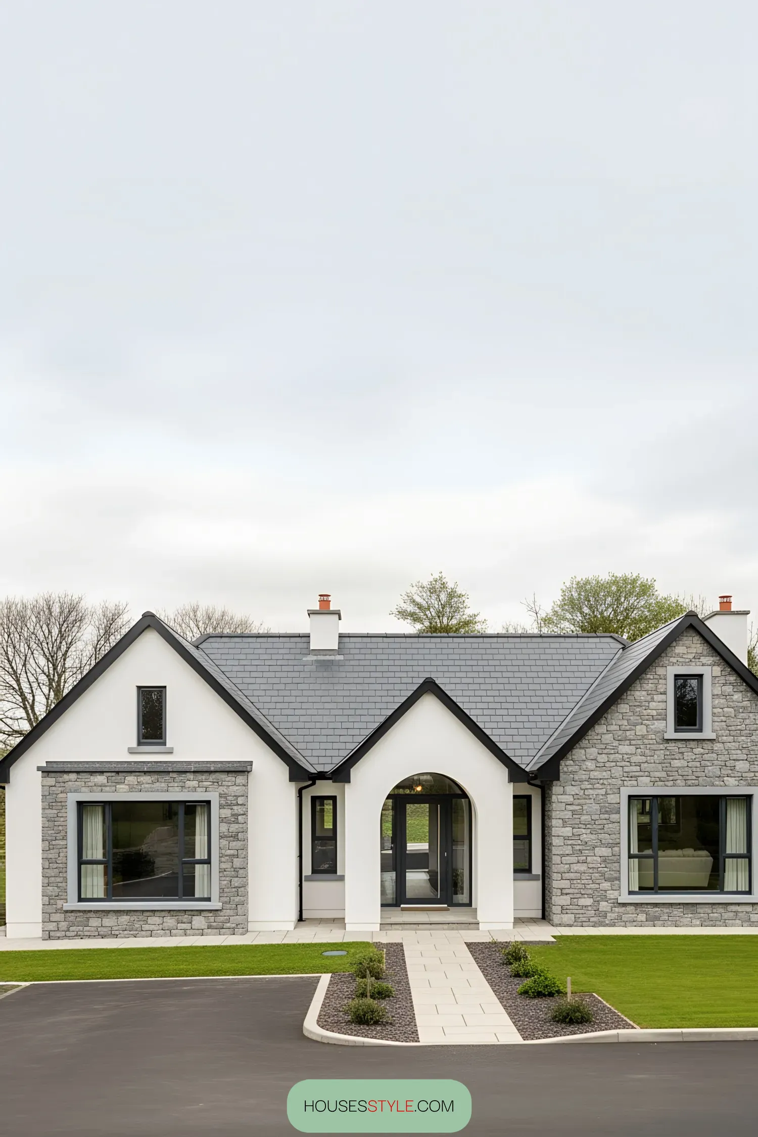 Whitewashed Irish bungalow with stone accents and manicured lawn