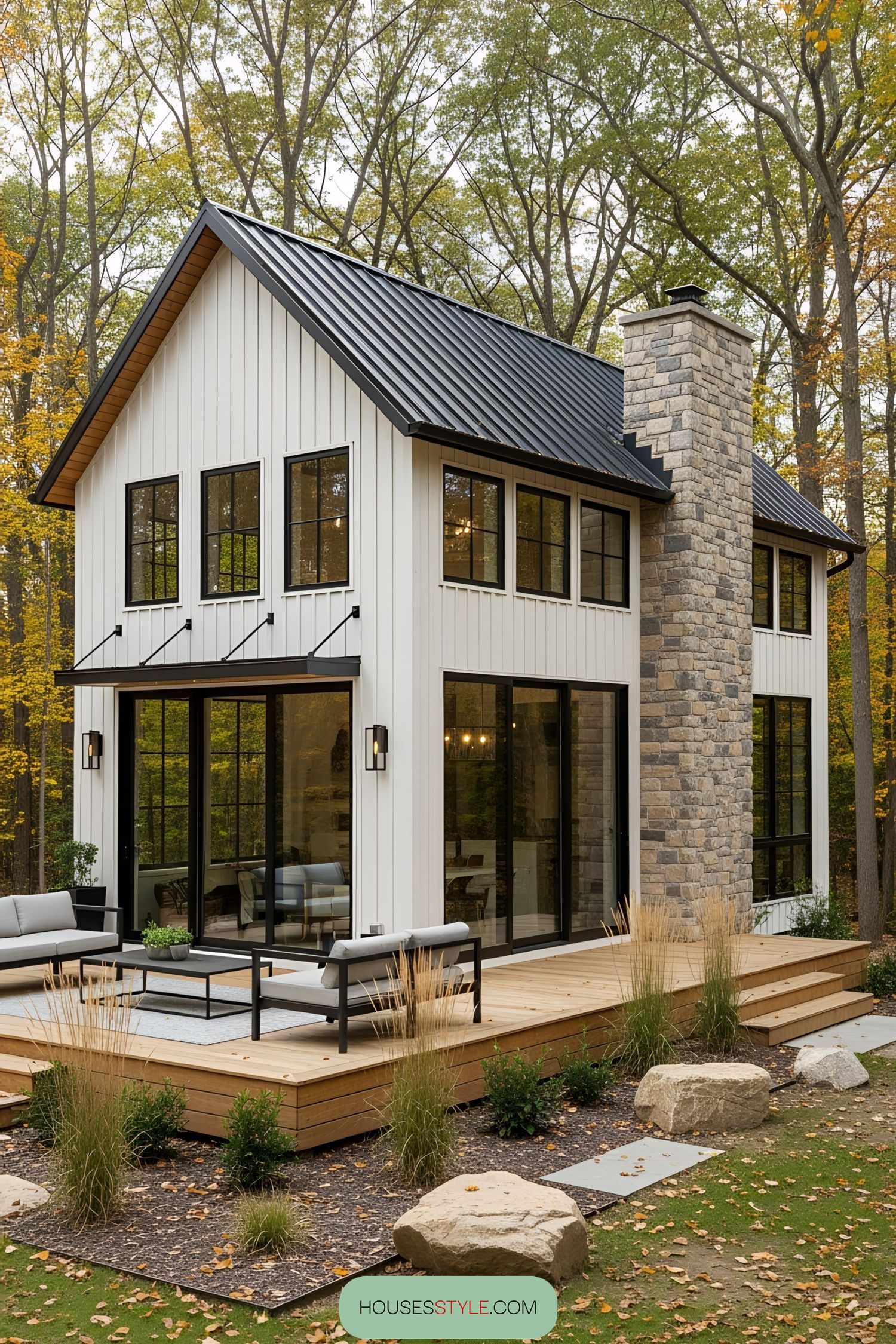 Modern rustic house with large windows and a stone chimney