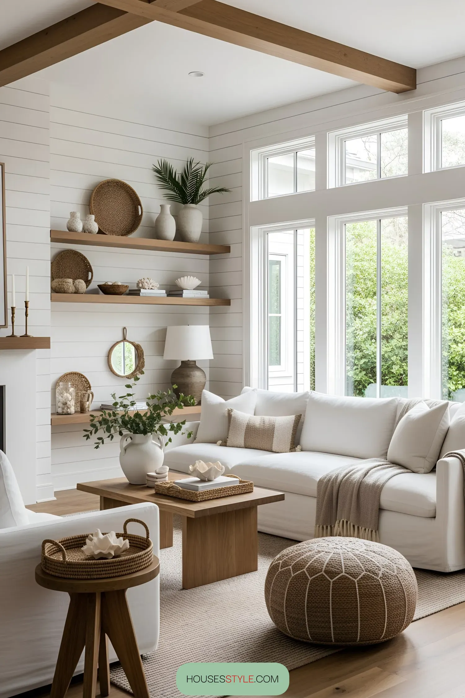 Bright beach-themed living room with white furniture and wood accents