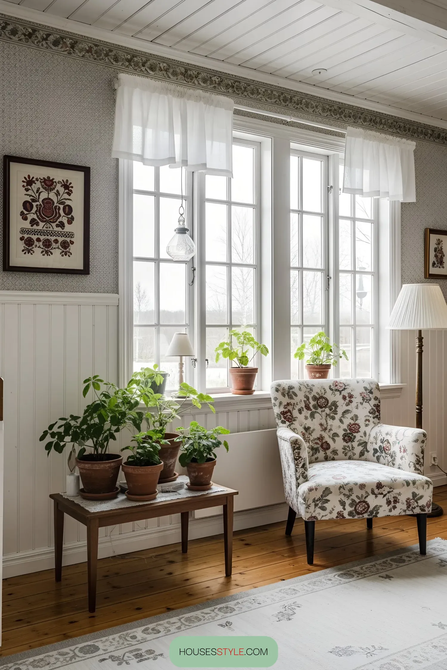 Bright, airy room with floral armchair and potted plants