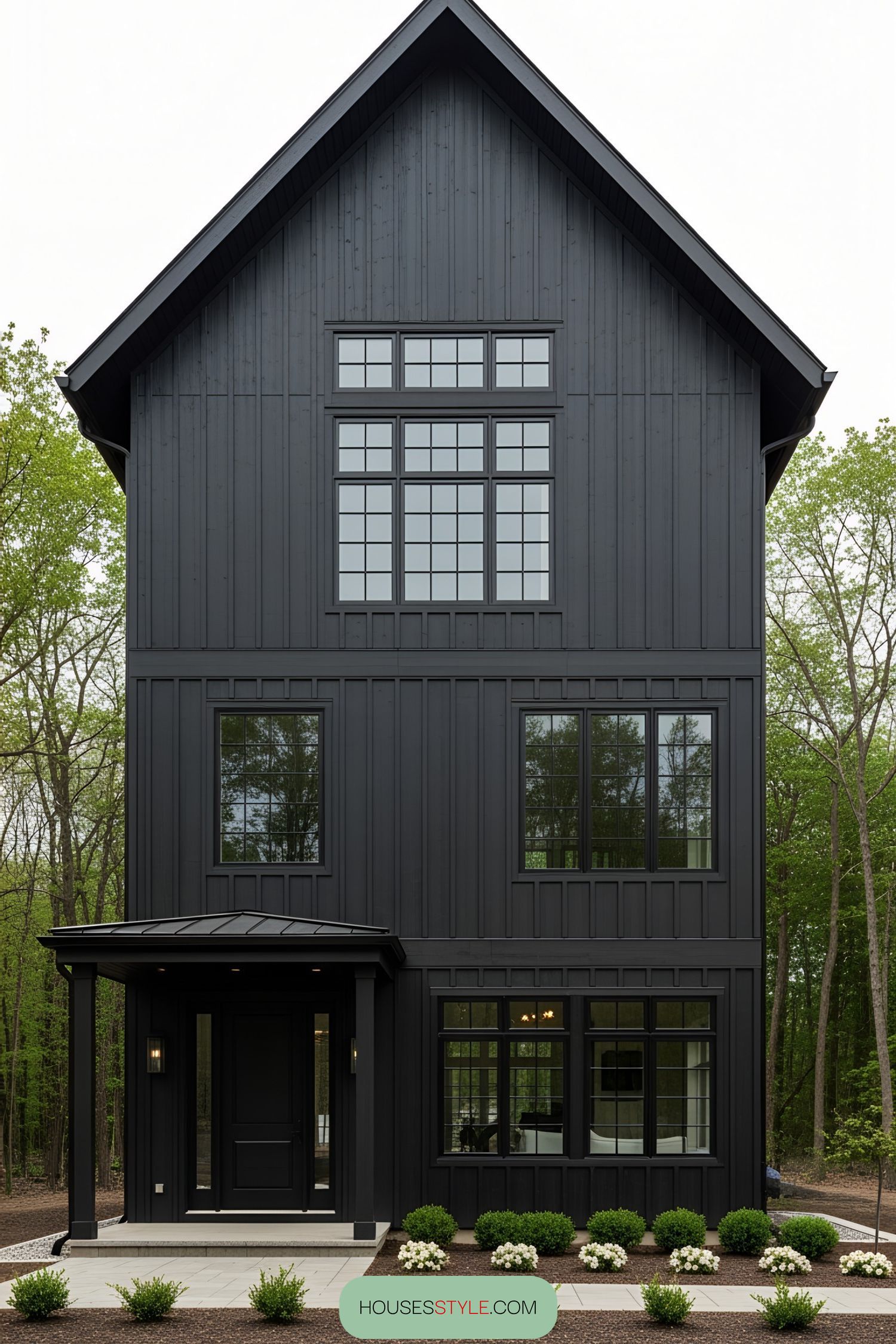 Tall black barn-style house with large windows