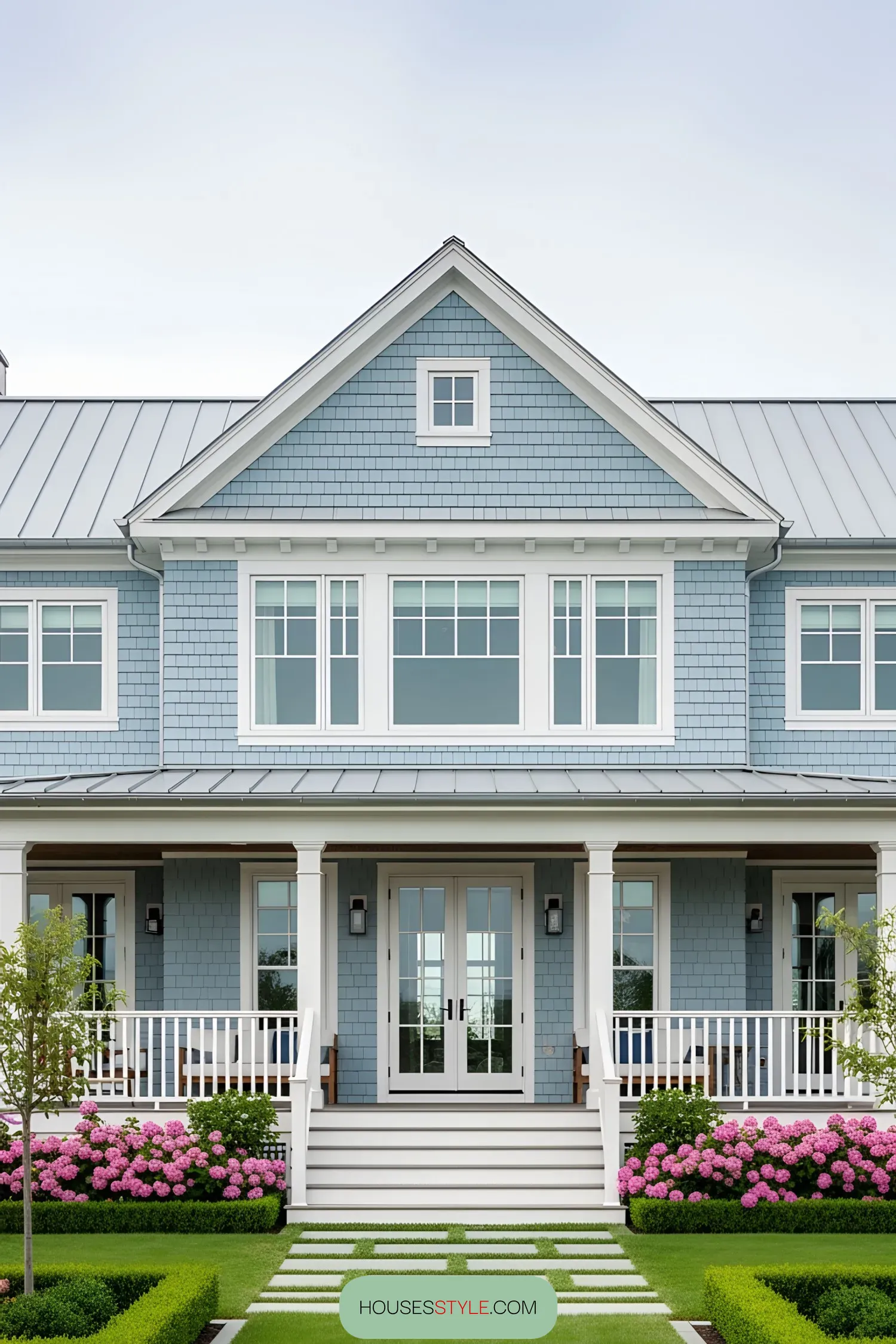 Elegant coastal house with blue siding and white trim