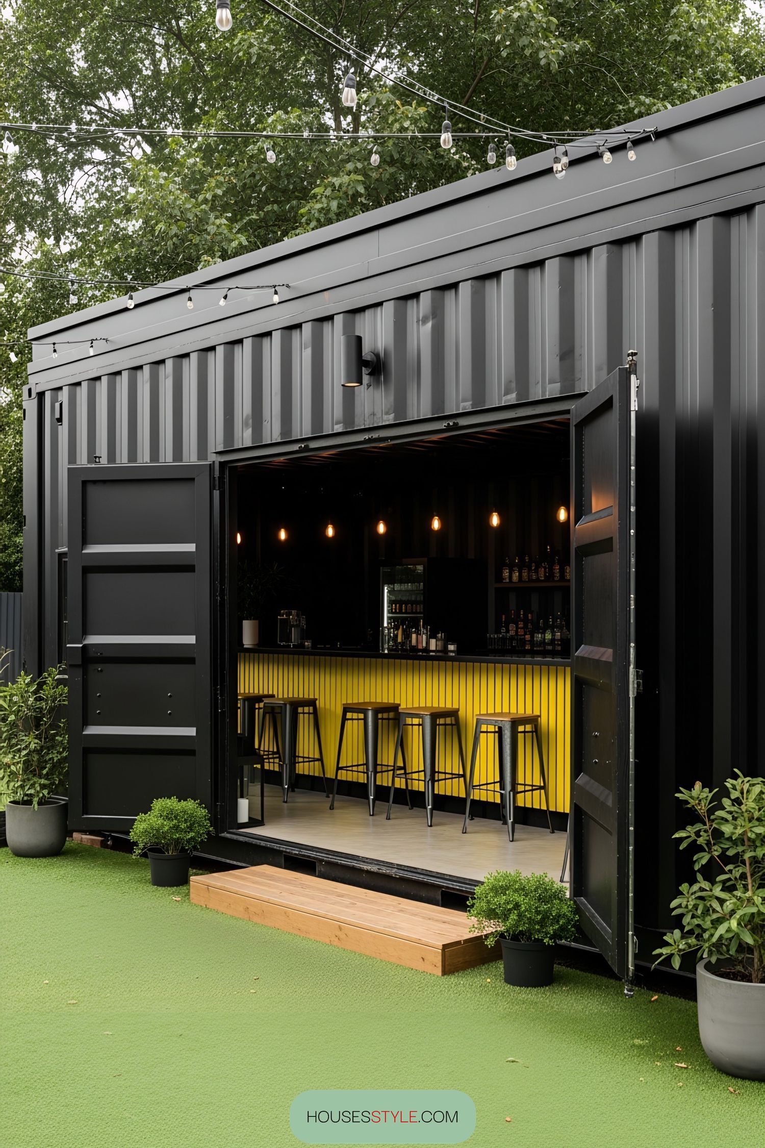 Shipping container bar with stools and hanging lights