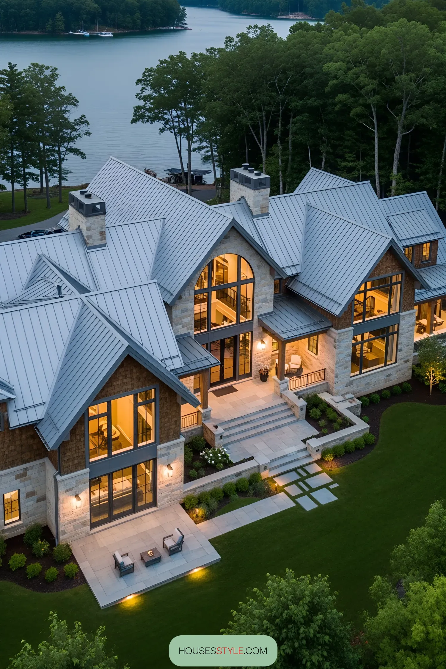 Grand lake house with metal roof and large windows