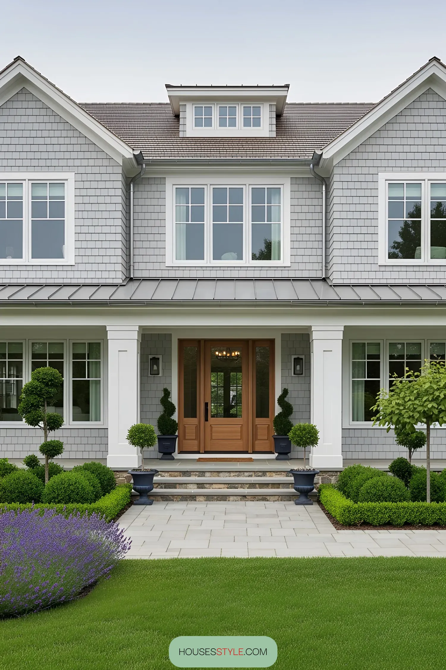 Modern coastal home with lush greenery and elegant entryway