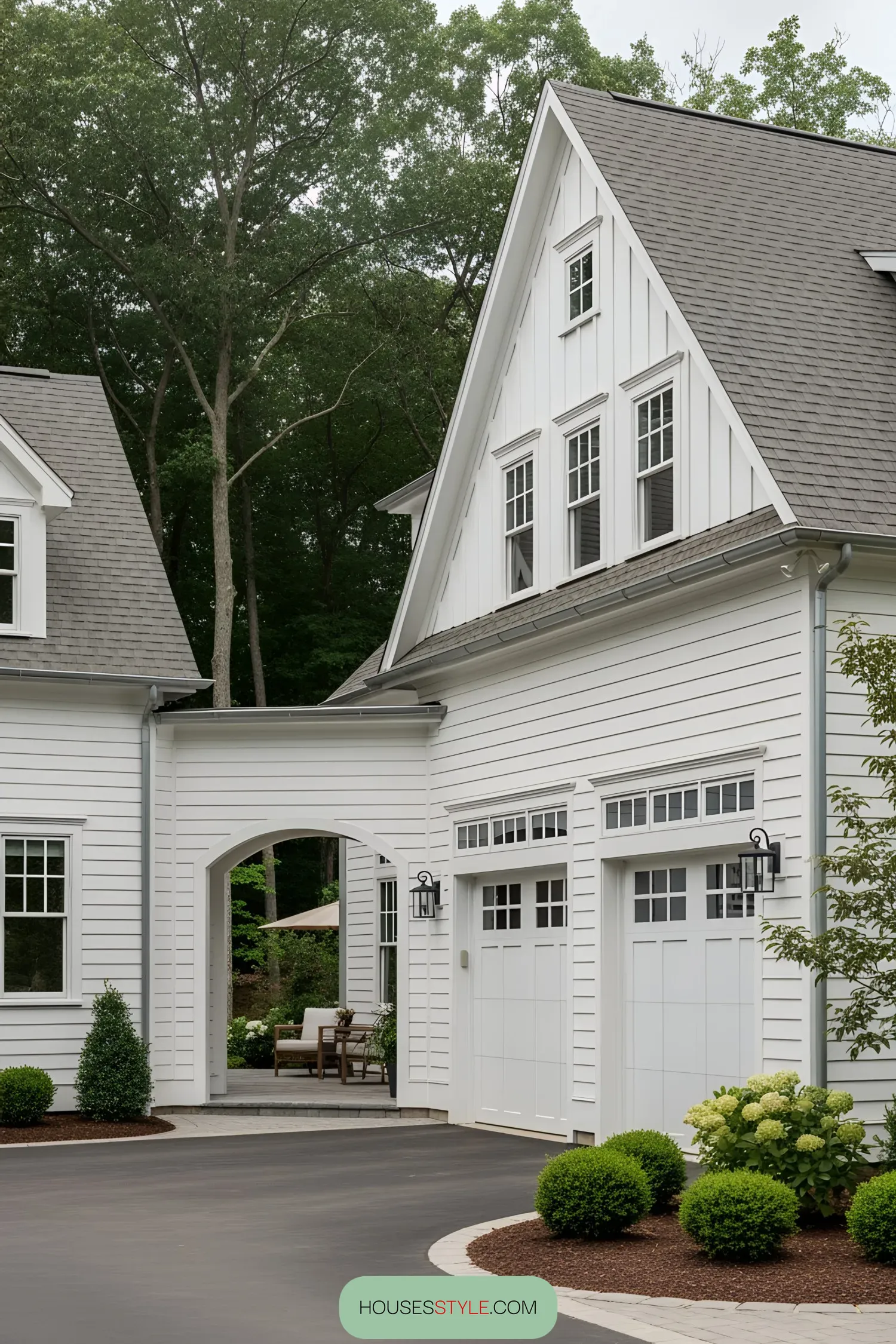 White farmhouse with gray roof and attached garage