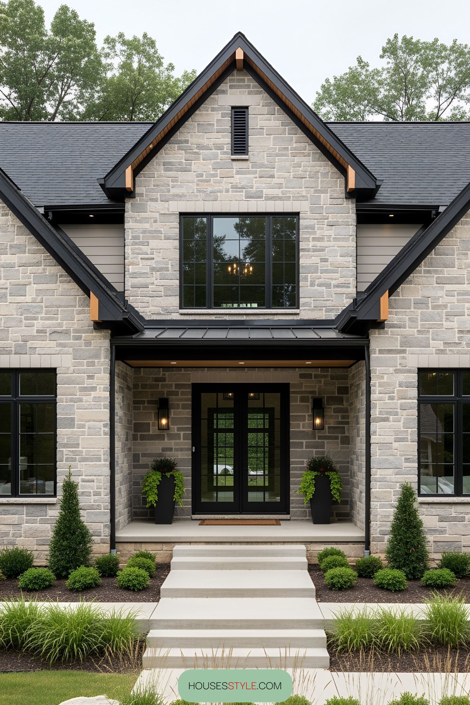 Modern brick farmhouse with large black-framed windows and lush front greenery