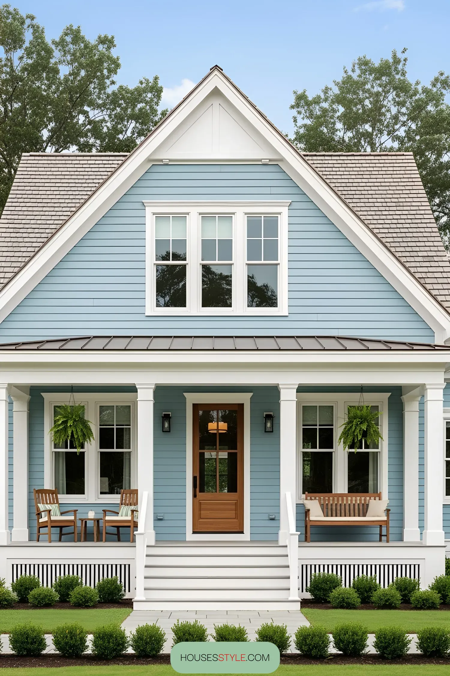 Small blue coastal house with a bright front porch and white trim