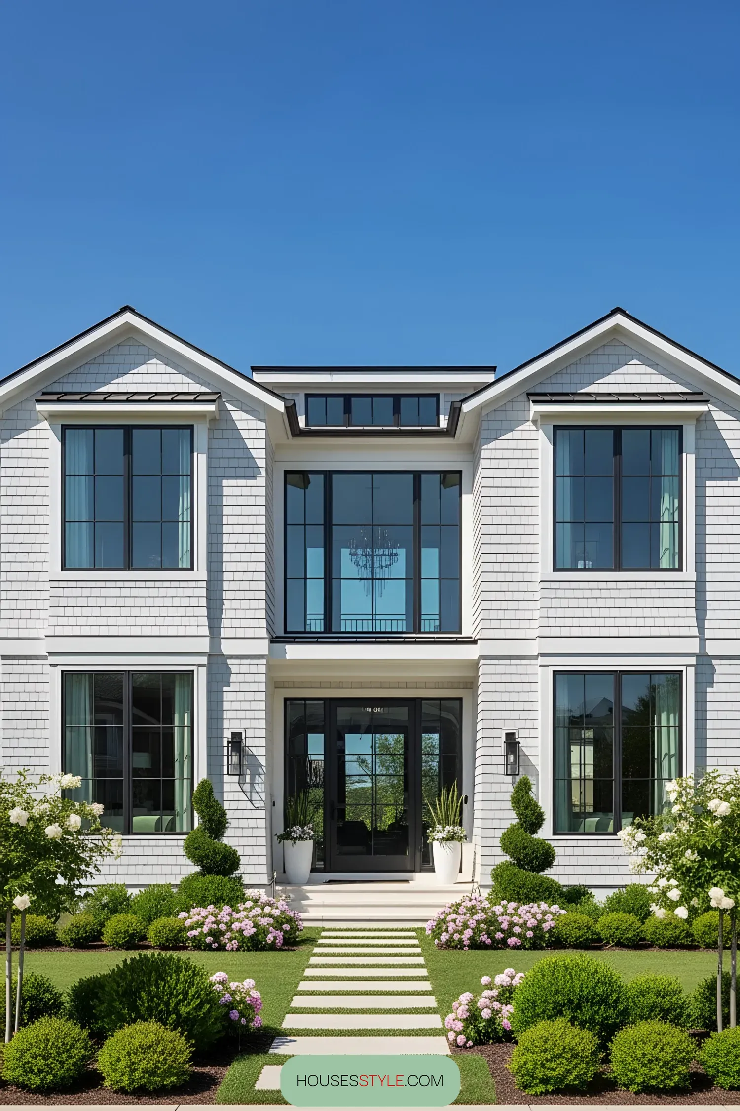 Contemporary white coastal house with manicured garden