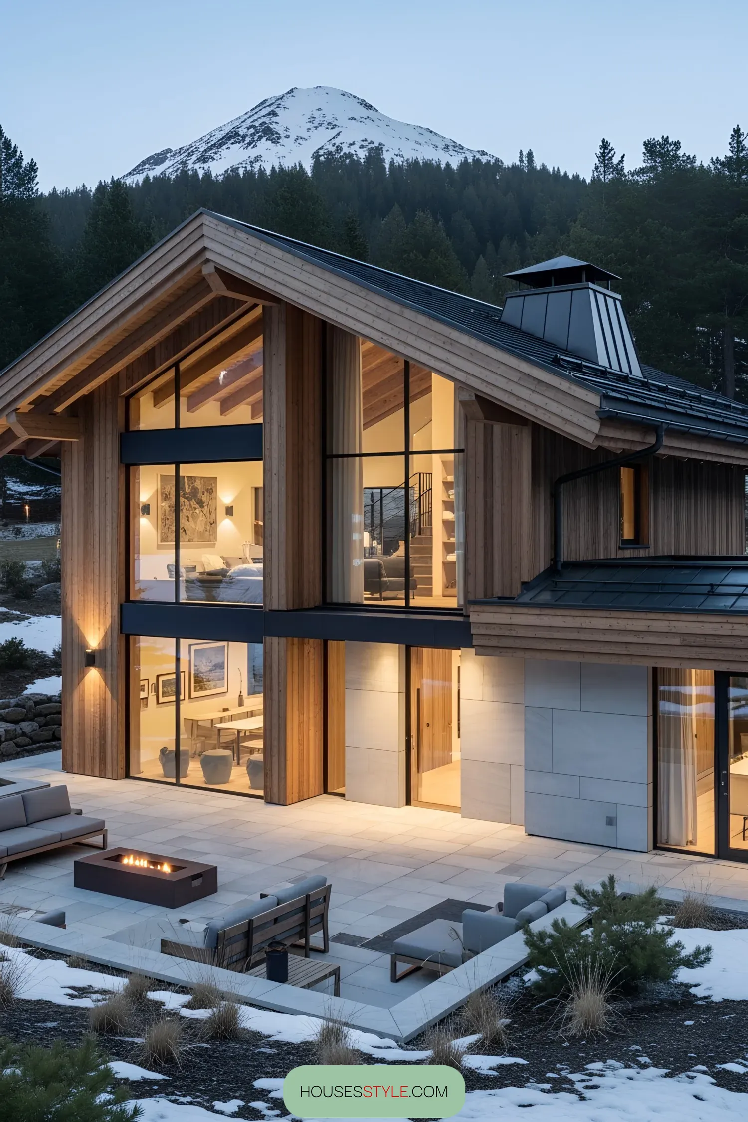 Luxury chalet with expansive windows and mountain backdrop