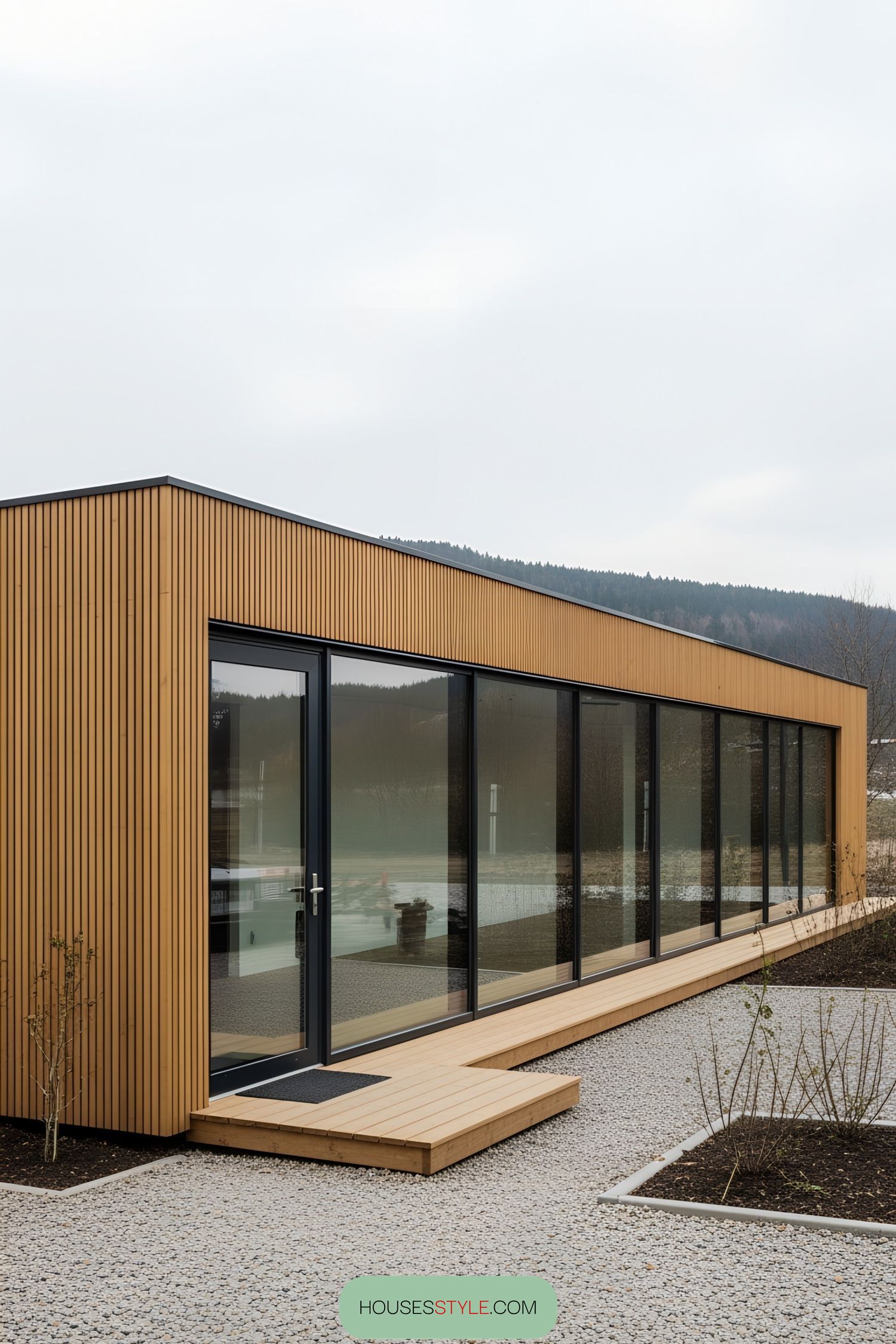 Container office with large windows and wooden exterior