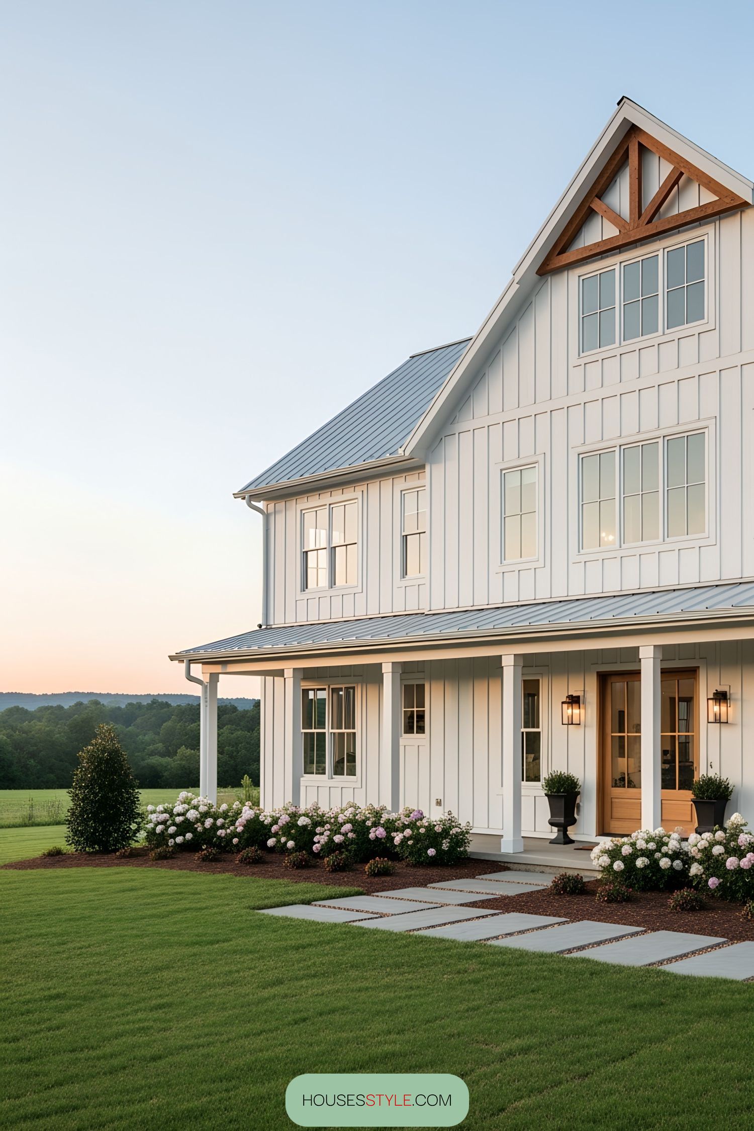 A picturesque white barn house at sunset with lush greenery