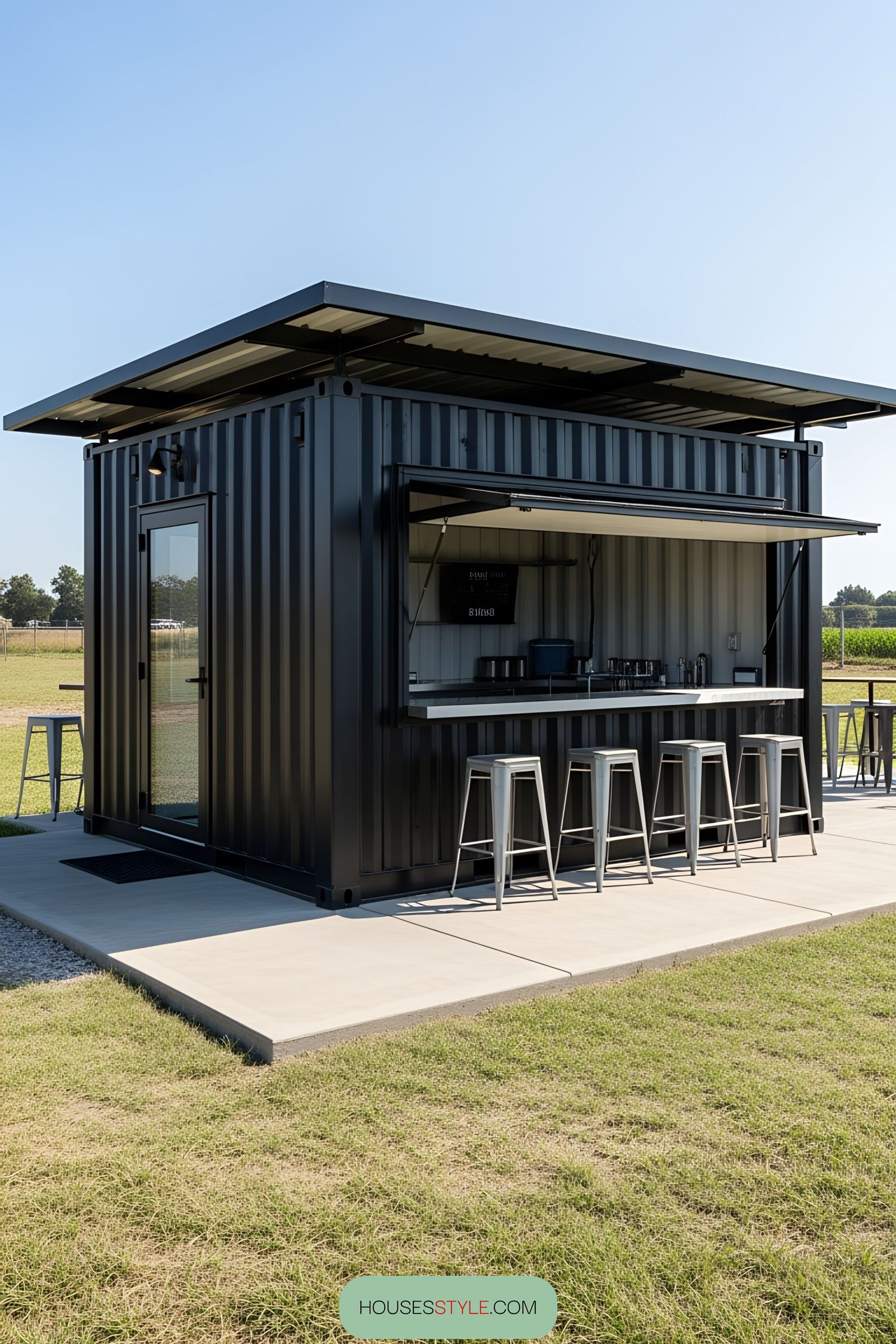 Small container bar with metal stools and open serving window