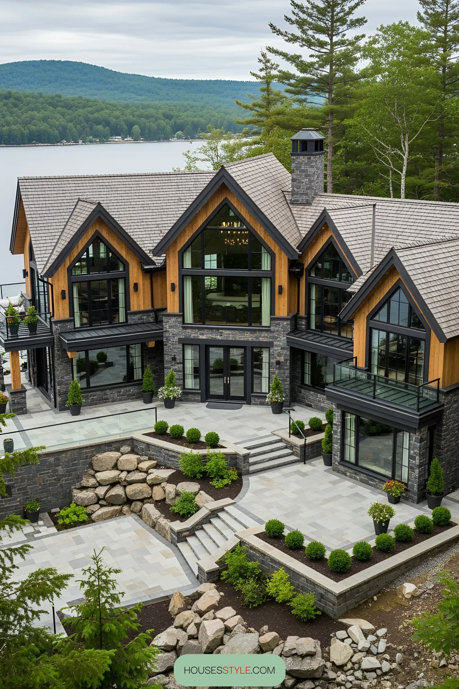 Luxurious lakeside house with large windows and stone facade