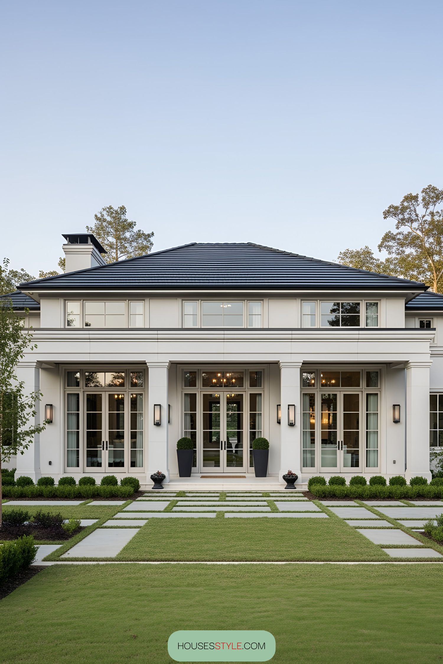 Sleek modern home entrance with large windows and manicured lawn