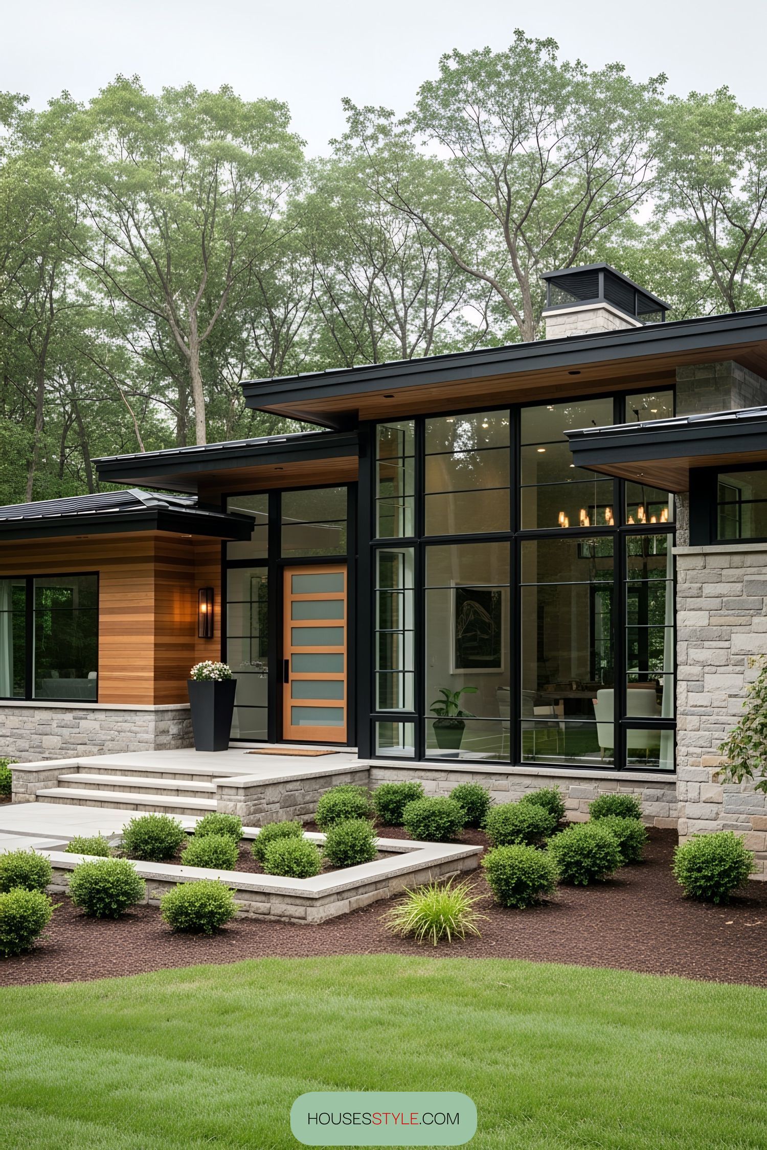 Modern one-story home with large windows and lush landscaping