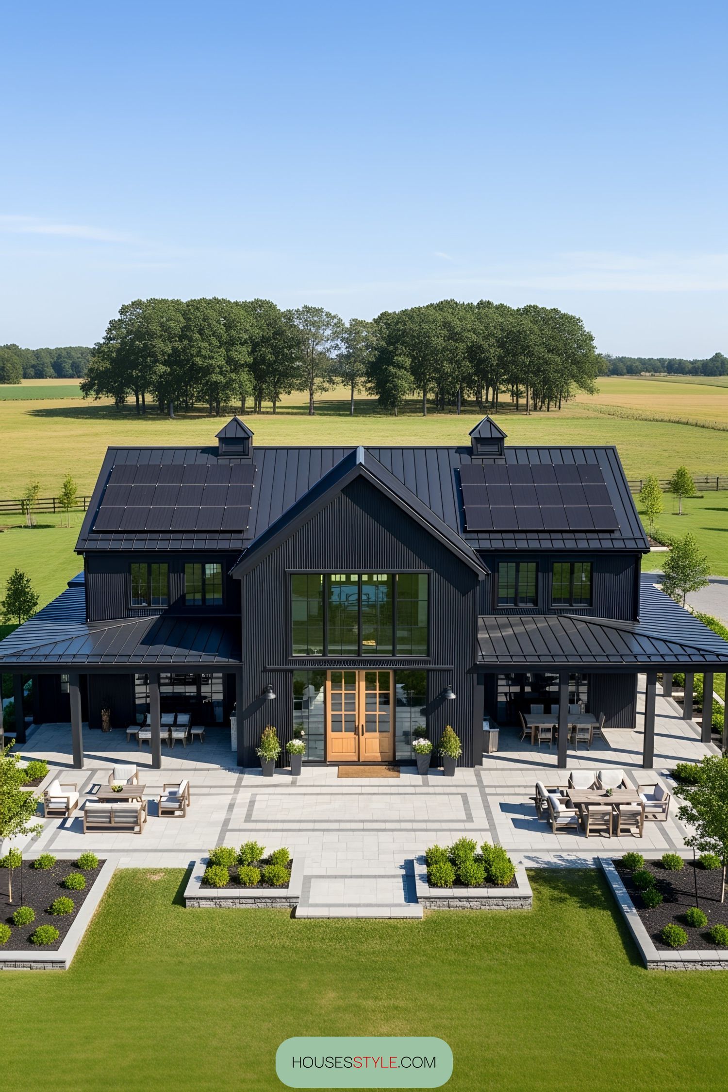 Sleek black barn house with solar panels and spacious patio